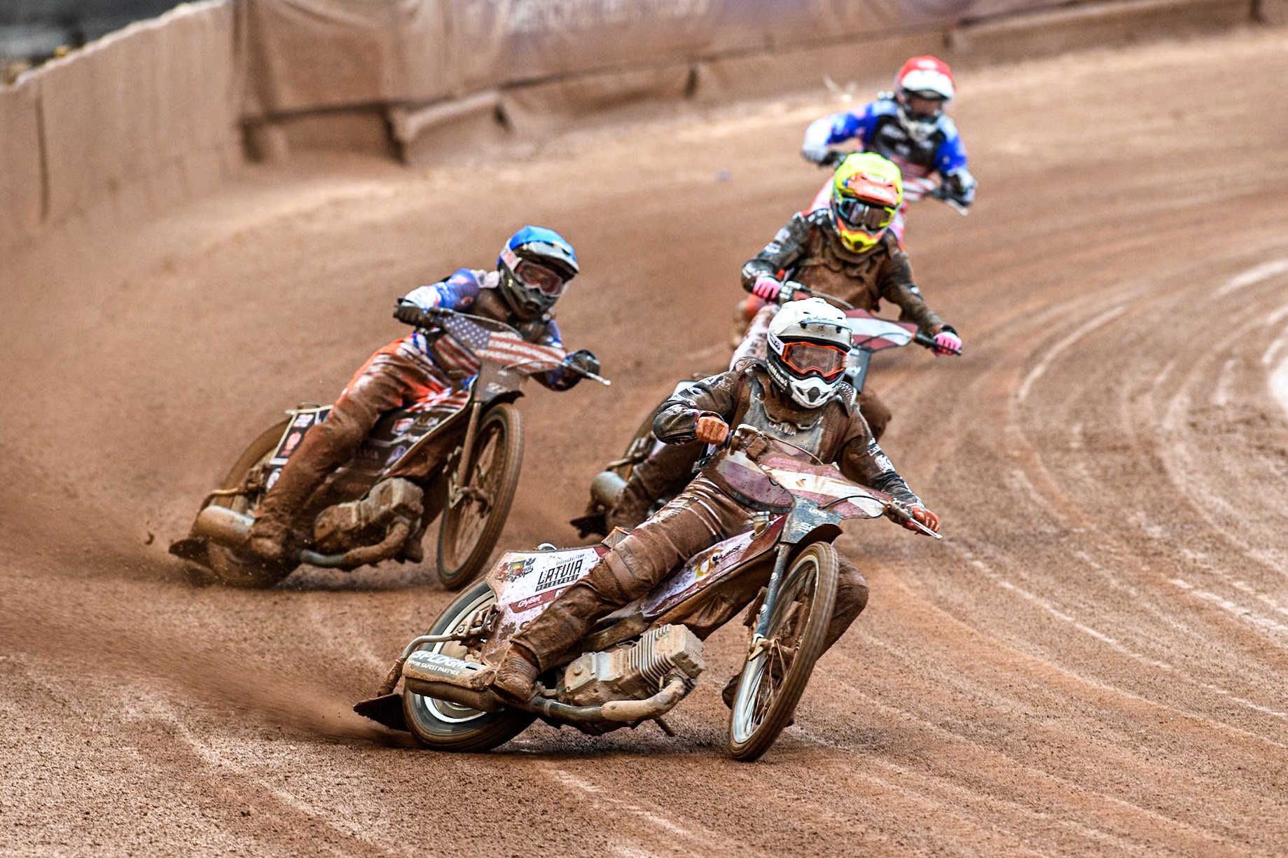 Andzejs Lebedevs of Latvia in White leading Luke Becker of the USA in Blue Daniils Kolodinskis of Latvia in Yellow and Broc Nicol of the USA in Red during the Monster Energy FIM Speedway of Nation Semi Final 2 at the National Speedway Stadium, Manchester on Wednesday 10th July 2024. (Photo: Ian Charles | MI News)