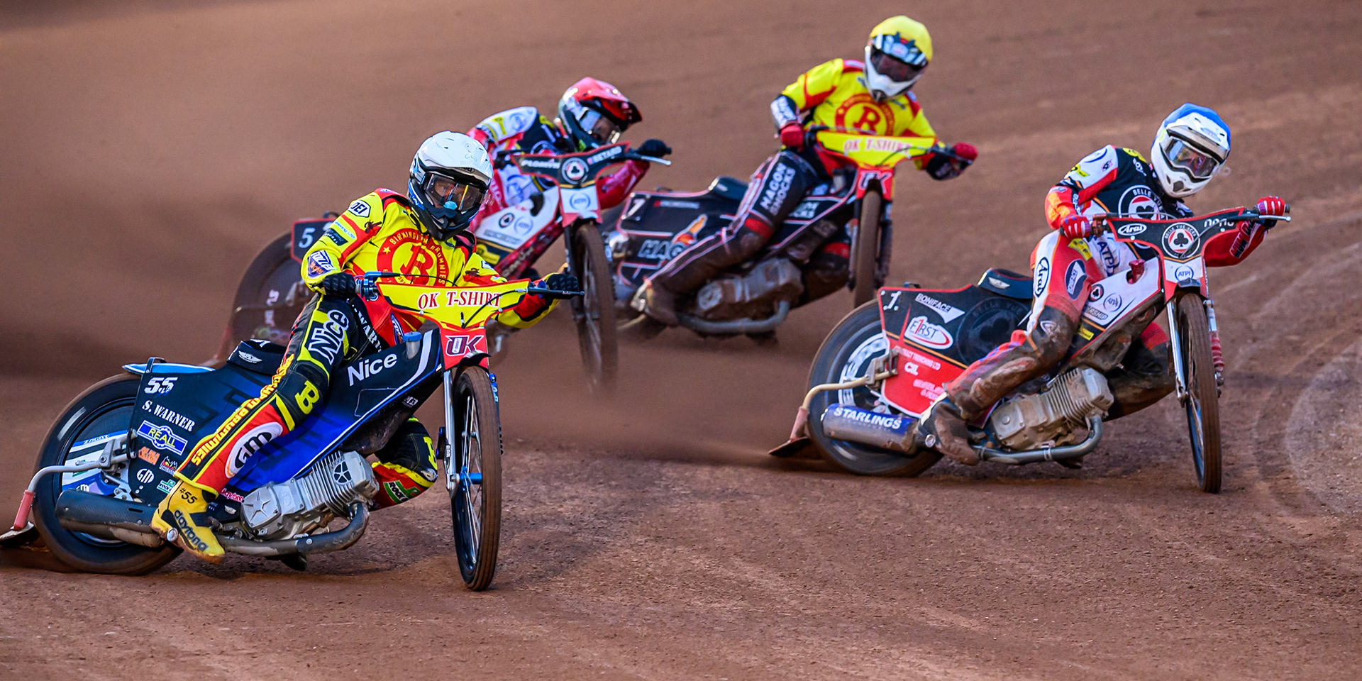 Matej Zagar of Birmingham Brummies  in Red rides outside Jake Mulford of Belle Vue Aces  in Blue, with Dan Bewley of Belle Vue Aces  in Red and Sam Hagon of Birmingham Brummies  in Yellow behind during the Rowe Motor Oil Premiership match between Belle Vue Aces and Birmingham Brummies at the National Speedway Stadium, Manchester on Monday 18th August 2025. (Photo: Ian Charles | MI News)