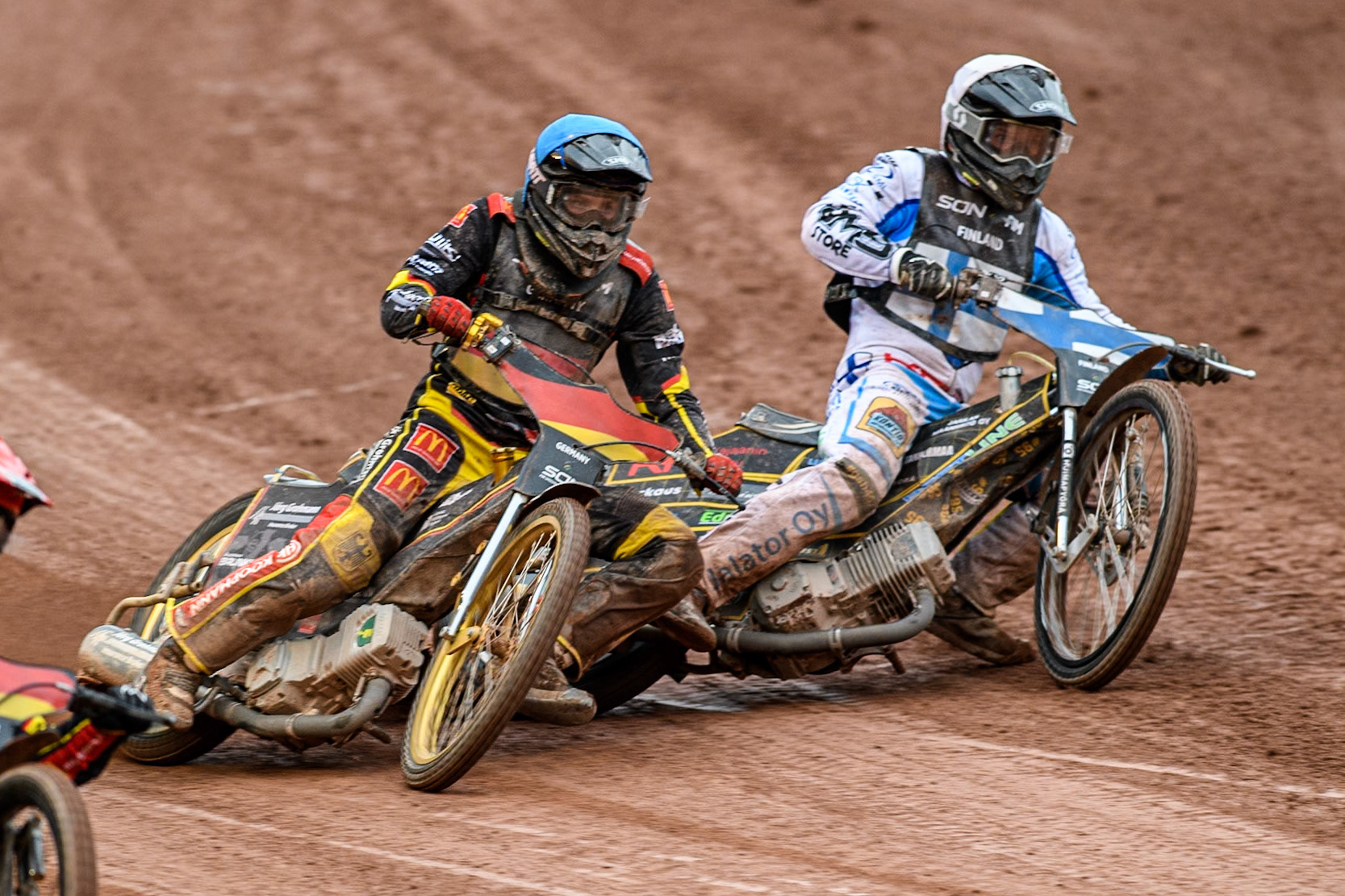 Germany v Finland: Norick Blödorn of Germany in Blue rides outside Jesse Mustonen of Finland in White during the Monster Energy FIM Speedway of Nations Semi-Final 1 at the National Speedway Stadium, Manchester on Tuesday 9th July 2024. (Photo: Ian Charles | MI News)