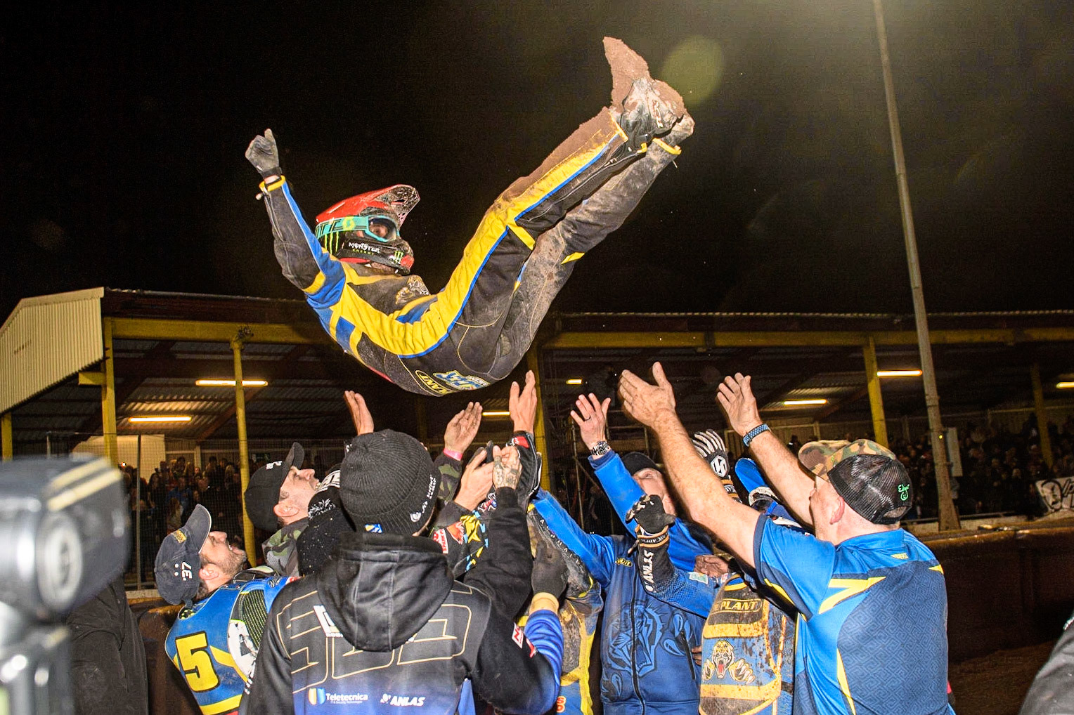 Chris Holder gets the victory bumps from the riders during the Sports Insure Premiership Grand Final Second Leg match between Sheffield Tigers and Ipswich Witches at Owlerton Stadium, Sheffield on Thursday 5th October 2023. (Photo: Ian Charles | MI News)