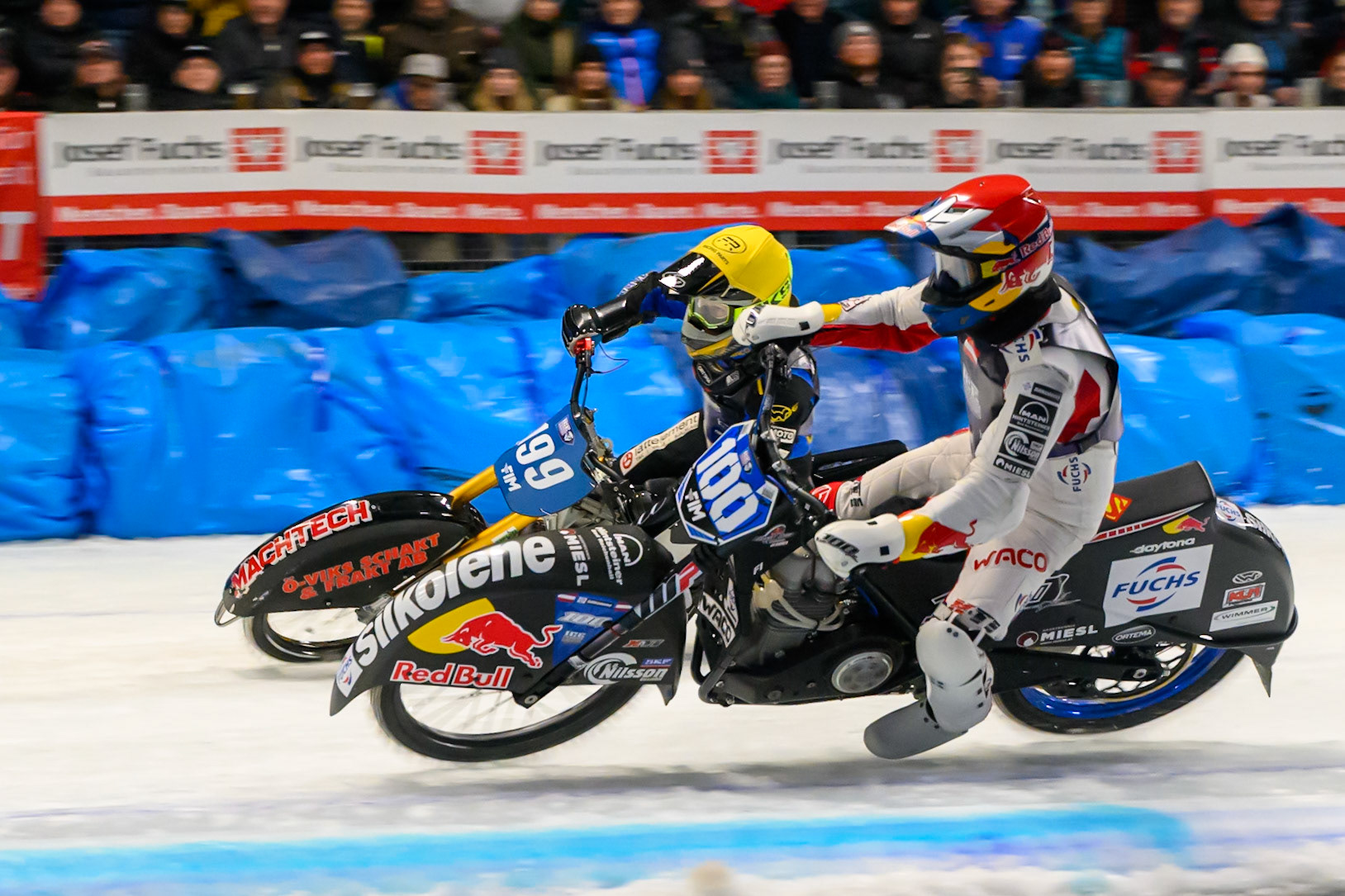 Franz Zorn (100) of Austria in Red rides inside Martin Haarahiltunen (199) of Sweden in Yellow behind during the Ice Speedway Gladiators World Championship Final 2 at Max-Aicher-Arena, Inzell on Sunday 15th March 2026. (Photo: Ian Charles | MI News)
