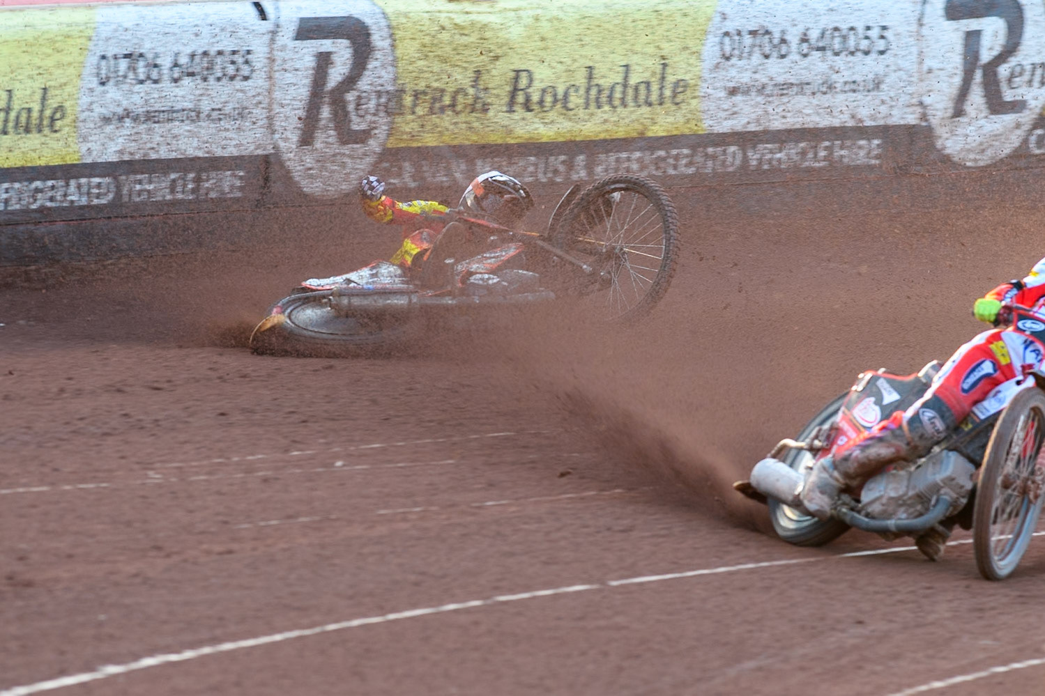 Leicester Lions' Sam Masters in White slides off outside of Belle Vue Aces' Jake Mulford in Blue during the Rowe Motor Oil Premiership match between Belle Vue Aces and Leicester Lions at the National Speedway Stadium, Manchester on Monday 19th May 2025. (Photo: Ian Charles | MI News)