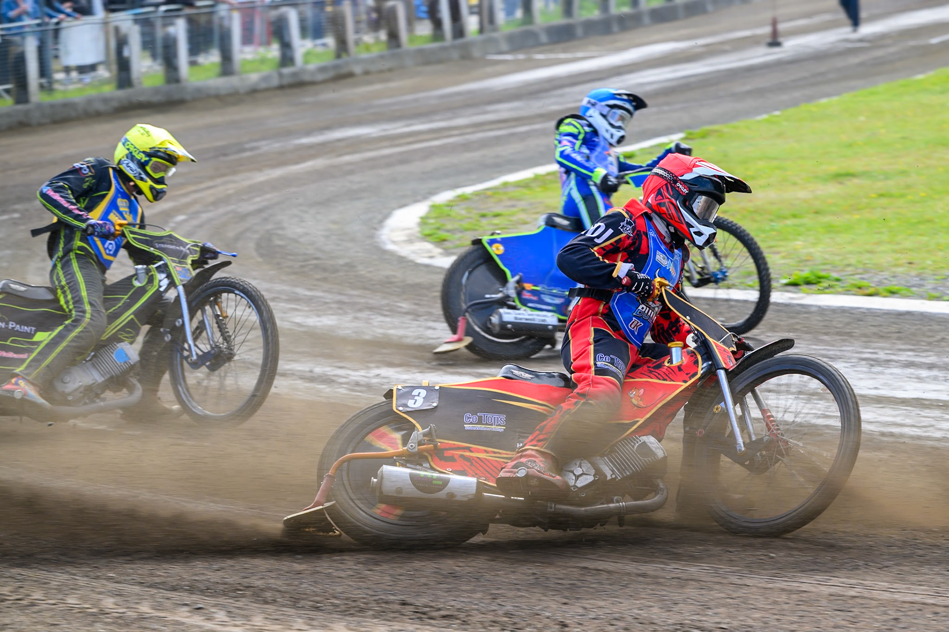 Luke Harris of Buxton Bulls in Red rides outside Arran Butcher of Buxton Bulls in Blue with Ben Whalley of Edinburgh Monarchs Academy  in Yellow behind during the WSRA National Development League match between Buxton Bulls and Edinburgh Monarchs Academy at Hi-Edge Speedway, Buxton on Sunday 14th June 2026. (Photo: Ian Charles | MI News)