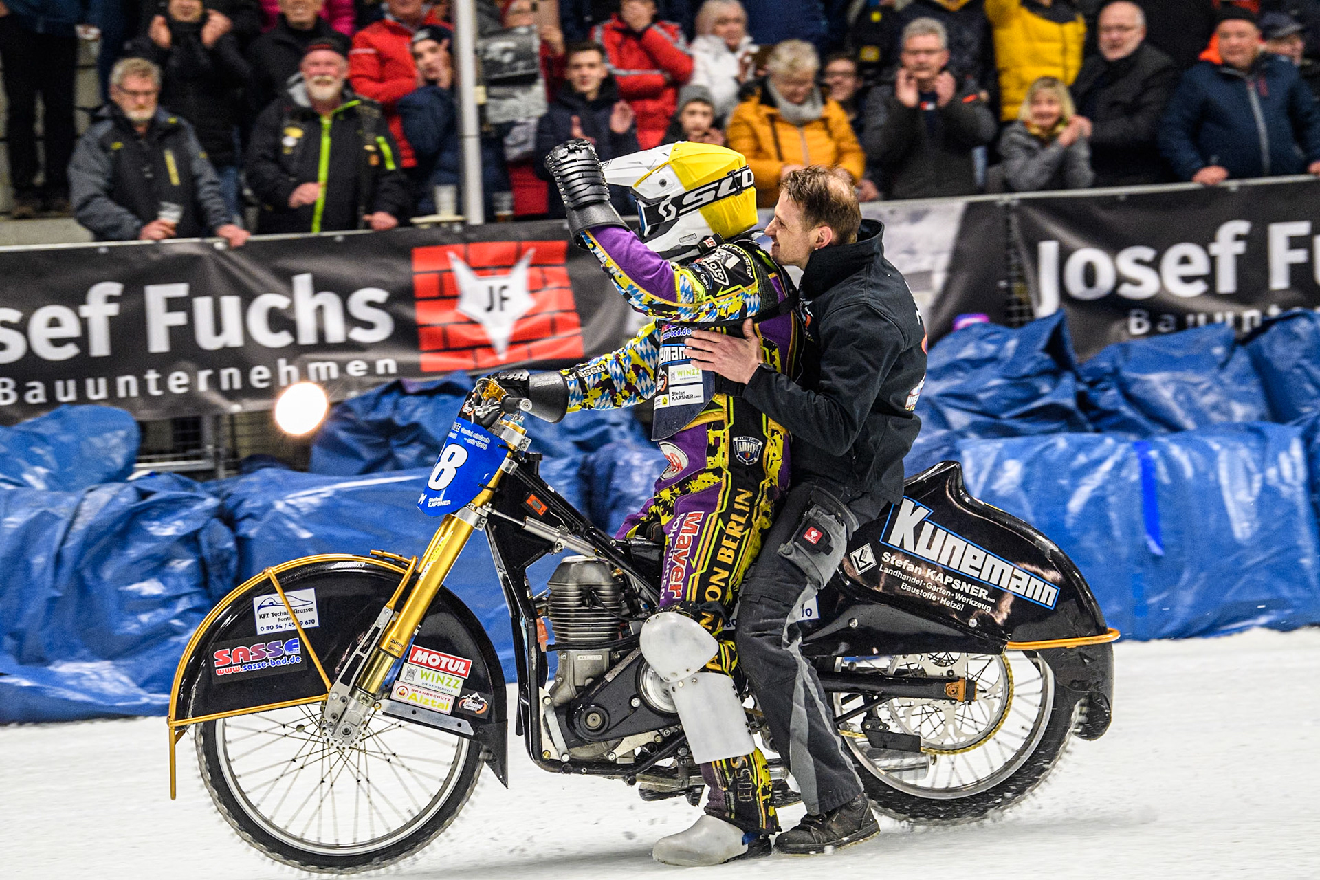 Germany's Max Niedermaier (88) and his mechanic do a lap of honour after winning the final; during the FIM Ice Speedway Gladiators World Championship Final 1 at the Max-Aicher-Arena, Inzell on Saturday 23 March 2024. (Photo: Ian Charles | MI News)
