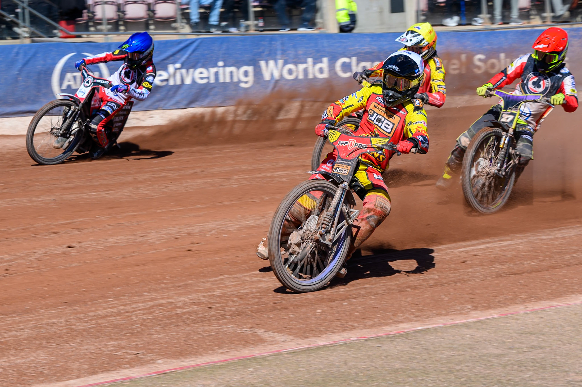 Ryan Douglas of Leicester Lions in White leading Tom Brennan Guest Rider for Belle Vue Aces  in Red, Dan Bewley  of Belle Vue Aces  in Blue and Sam Masters of Leicester Lions  in Yellow during the Knockout Cup Northern Section match between Belle Vue Aces and Leicester Lions at the National Speedway Stadium, Manchester on Monday 6th April 2026. (Photo: Ian Charles | MI News)