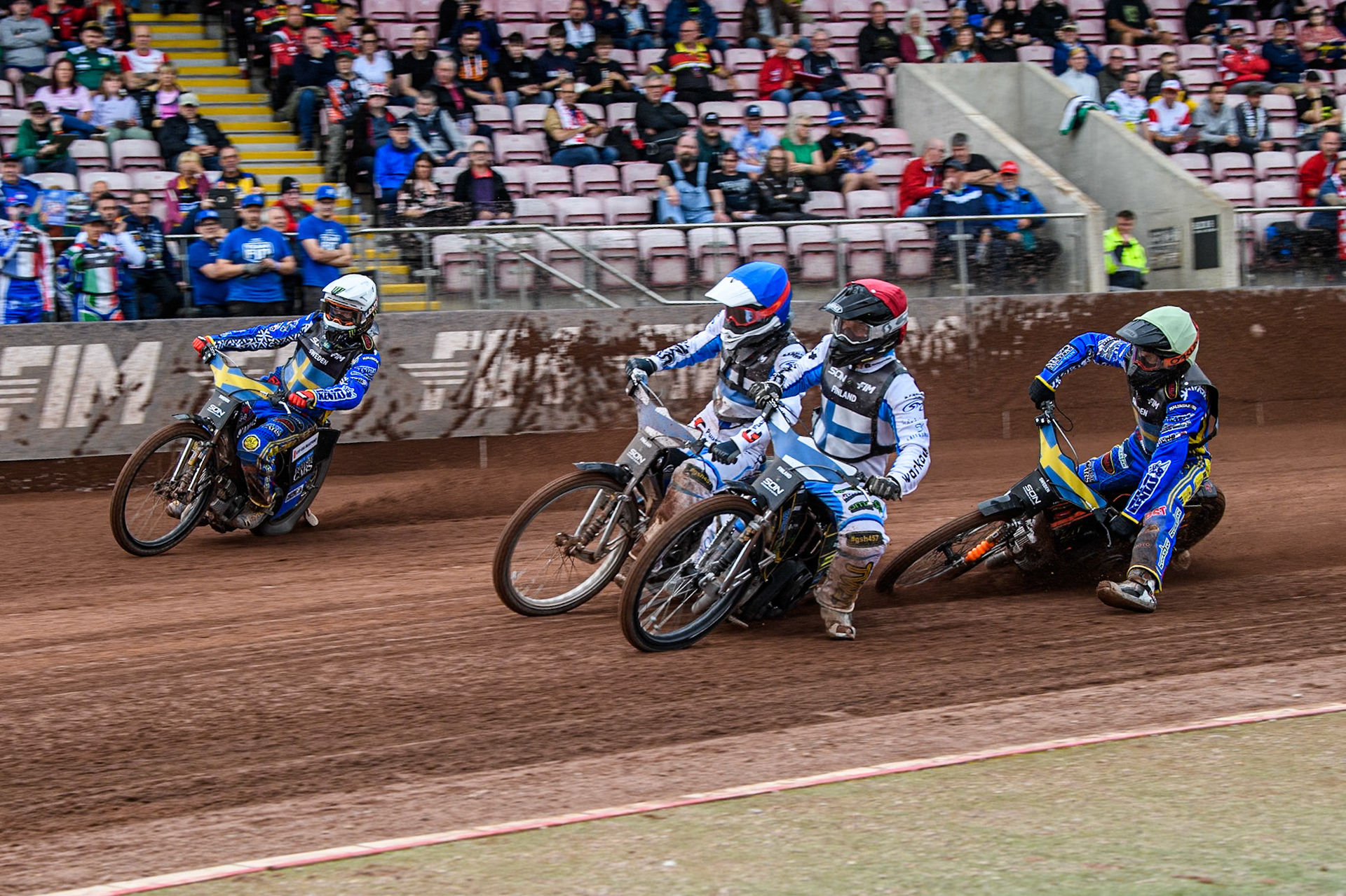 Finland v Sweden: Jesse Mustonen of Finland in Red rides inside Antti Vuolas of Finland and Fredrik Lindgren of Sweden in White with Jacob Thorssell of Sweden in Yellow behind during the Monster Energy FIM Speedway of Nations Semi-Final 1 at the National Speedway Stadium, Manchester on Tuesday 9th July 2024. (Photo: Ian Charles | MI News)