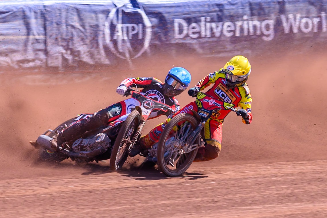 Kyle Howarth of Leicester Lions  in Yellow brings down Tate Zischke of Belle Vue Aces in Blue during the Knockout Cup Northern Section match between Belle Vue Aces and Leicester Lions at the National Speedway Stadium, Manchester on Monday 6th April 2026. (Photo: Ian Charles | MI News)