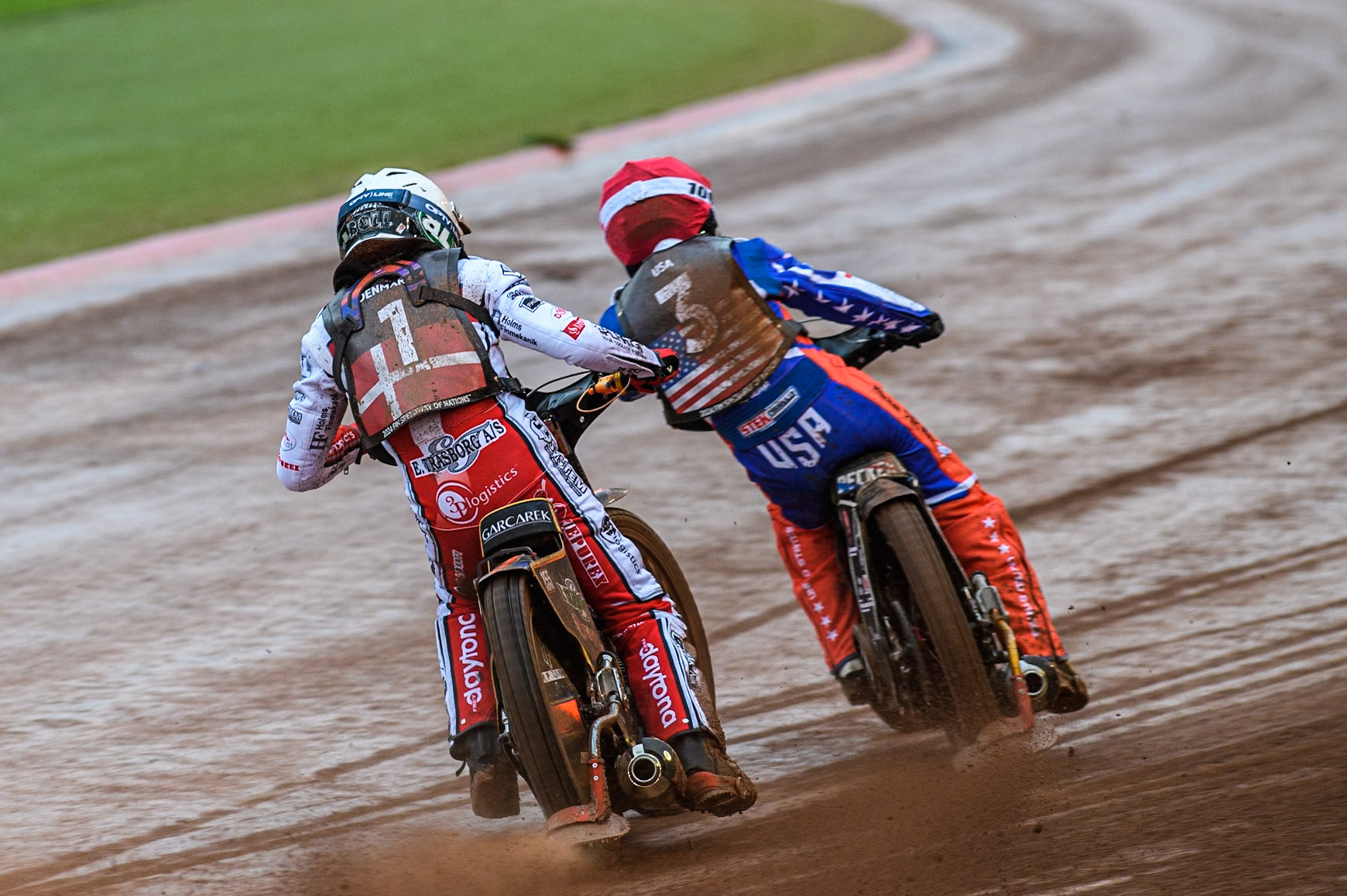 Mikkel Michelsen of Denmark in White chases Broc Nicol of the USA in Red during the Monster Energy FIM Speedway of Nation Semi Final 2 at the National Speedway Stadium, Manchester on Wednesday 10th July 2024. (Photo: Ian Charles | MI News)
