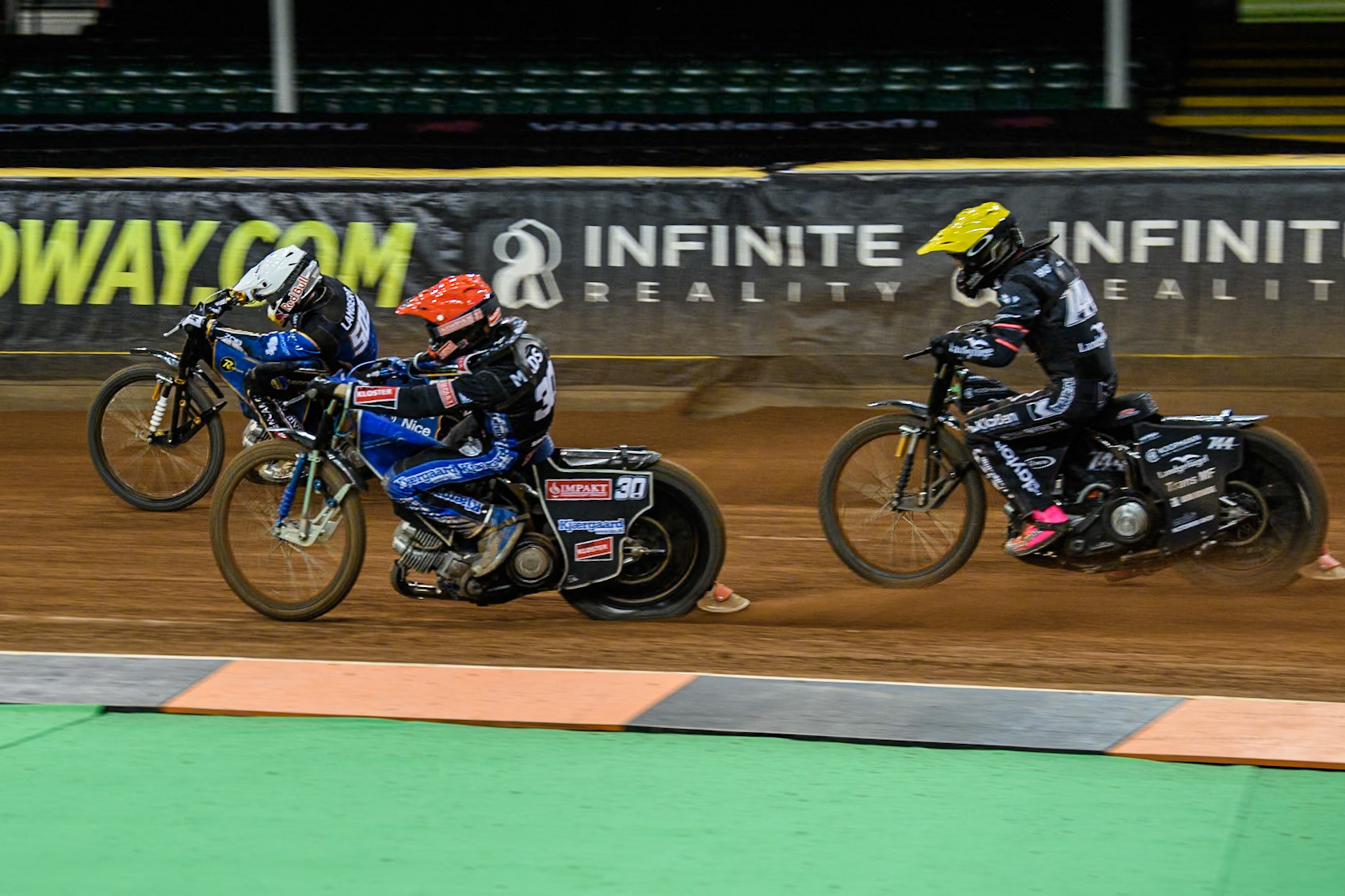 Leon Madsen (30) of Denmark in Red rides inside Robert Lambert (505) of Great Britain in White with Kai Huckenbeck (744) of Germany in Yellow behind during the FIM Speedway Grand Prix of Great Britain at The Principality Stadium, Cardiff on Saturday 17th August 2024. (Photo: Ian Charles | MI News)