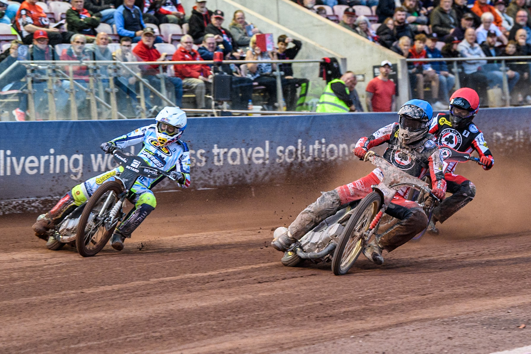 Belle Vue Aces' Norick Blodorn in Blue rides inside Oxford Spires' Maciej Janowski  in White with Belle Vue Aces' Brady Kurtz  in Red behind during the Rowe Motor Oil Premiership match between Belle Vue Aces and Oxford Spires at the National Speedway Stadium, Manchester on Monday 22nd July 2024. (Photo: Ian Charles | MI News)