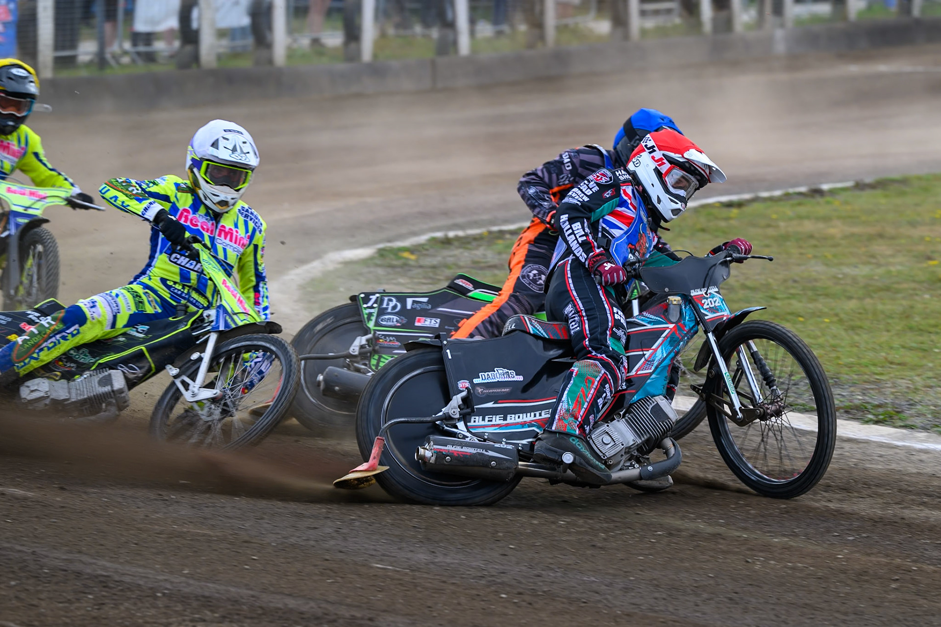 Darryl Ritchings of Oxford Chargers in White  falls after clipping the back wheel of Jack Roberts of Buxton Bulls in Blue  with Alfie Bowtell of Buxton Bulls in Red  eading during the WSRA National Development League match between Buxton Bulls and Oxford Chargers at Hi-Edge Speedway, Buxton on Sunday 2nd August 2026. (Photo: Ian Charles | MI News)