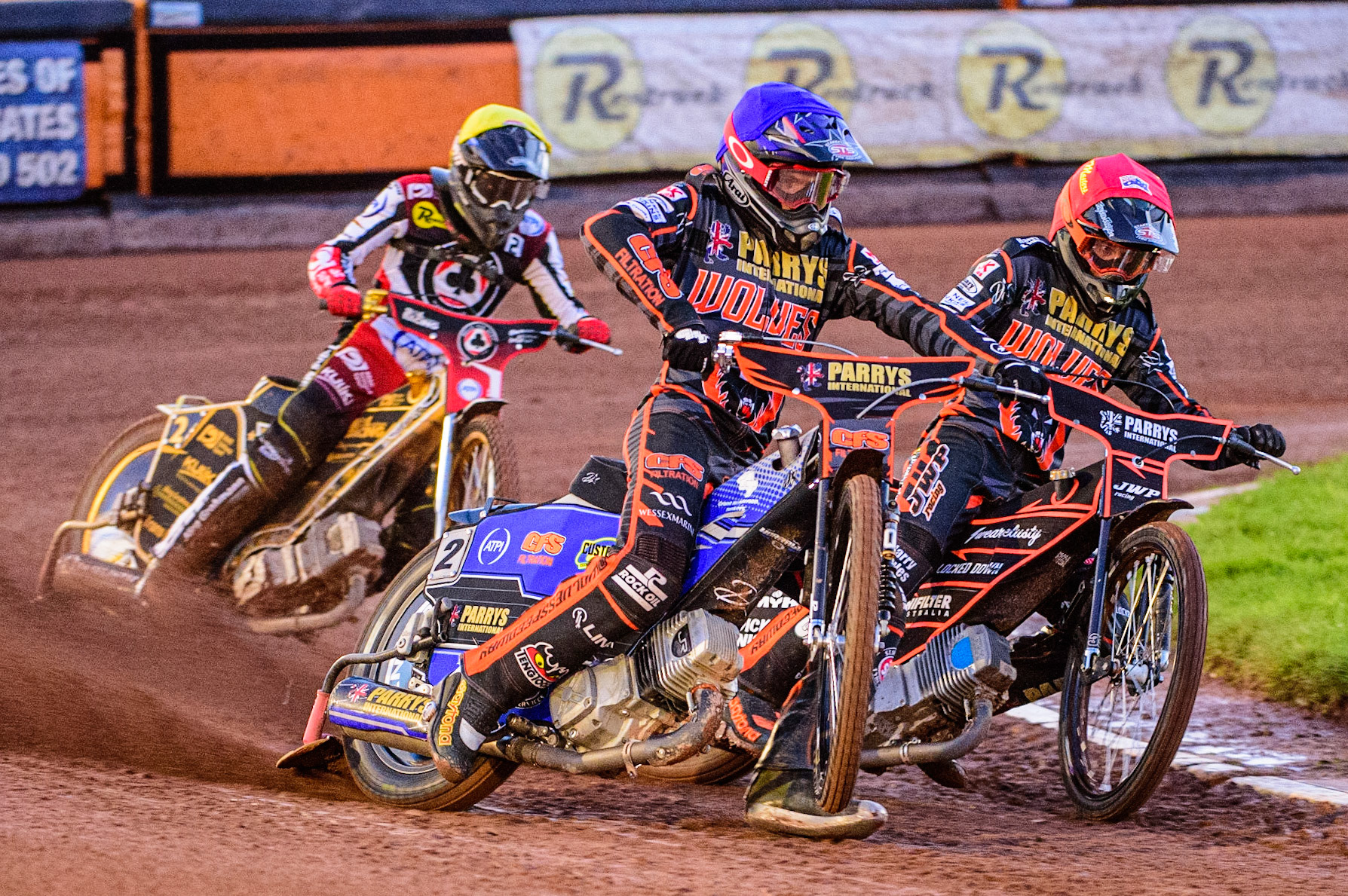 Steve Worrall (Blue) picks up some drive outside Sam Masters  (Red) with Norick Blodorn  (Yellow) behind during the SGB Premiership Knock Out Cup Quarter Final 1st Leg between Wolverhampton Wolves and Belle Vue Aces at Monmore Green Stadium, Wolverhampton on Monday 10th April 2023. (Photo: Ian Charles | MI News)