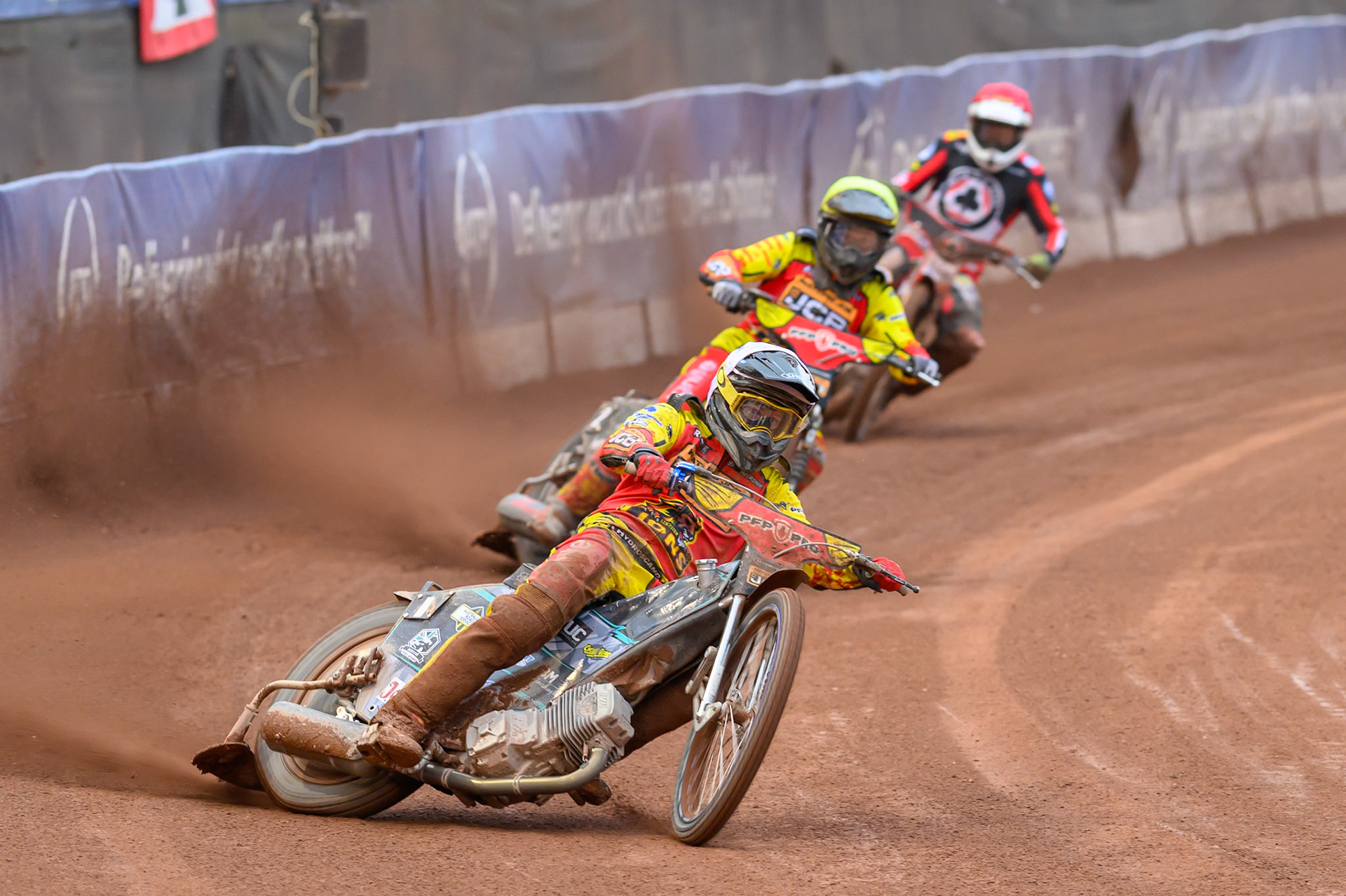 Ryan Douglas of Leicester Lions in White leading Dan Thompson of Leicester Lions in Yellow and Peter Kildemand of Belle Vue Aces in Red during the Rowe Motor Oil Premiership match between Belle Vue Aces and Leicester Lions at the National Speedway Stadium, Manchester on Monday 15th June 2026. (Photo: Ian Charles | MI News)