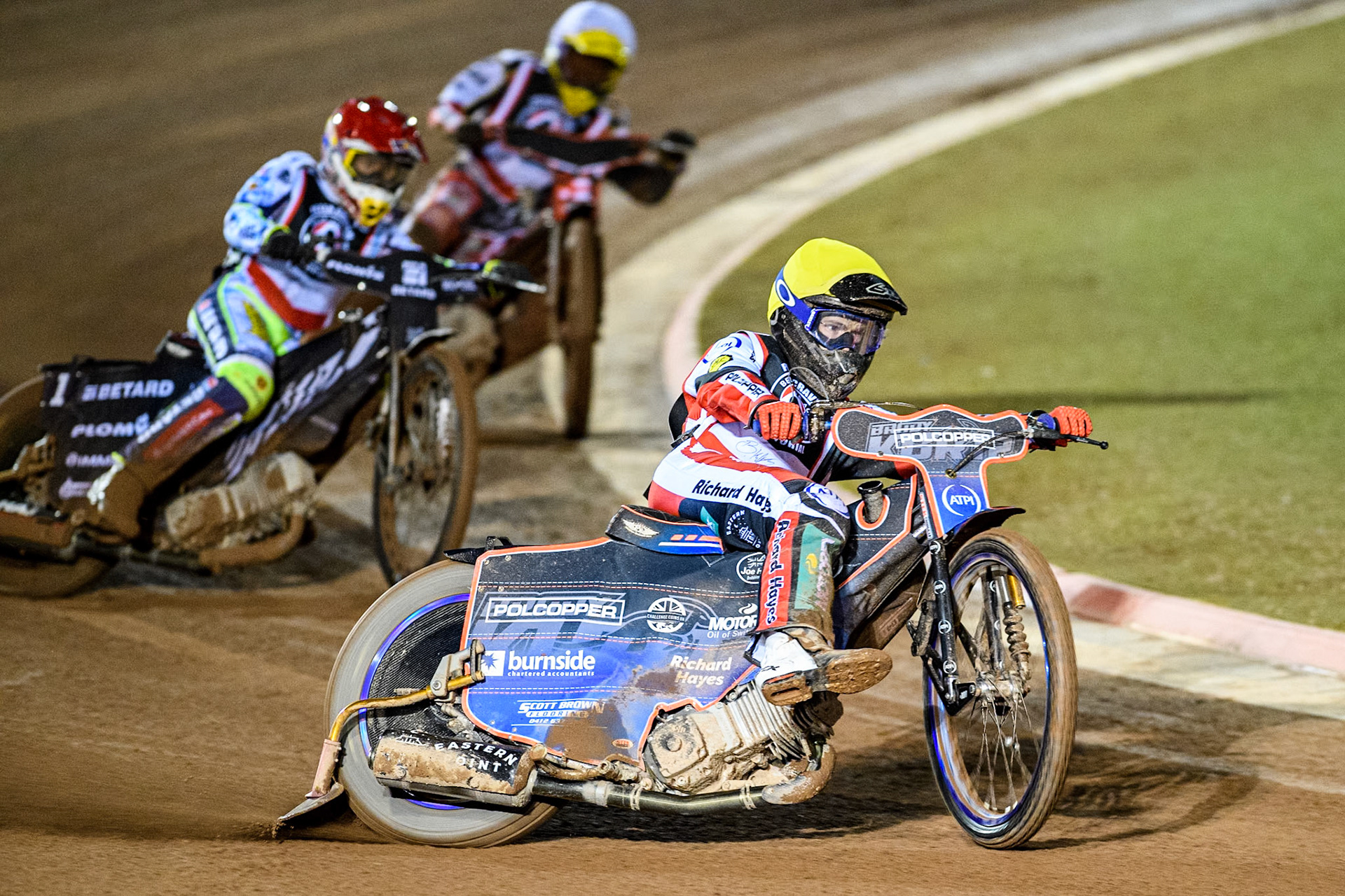 Australia's Brady Kurtz (Yellow) leads Poland’s Maceij Janowski (Red) and Poland's Patryk Wojdylo (White) during the Peter Craven Memorial Trophy meeting at the National Speedway Stadium, Manchester on Monday 18th March 2024. (Photo: Ian Charles | MI News)