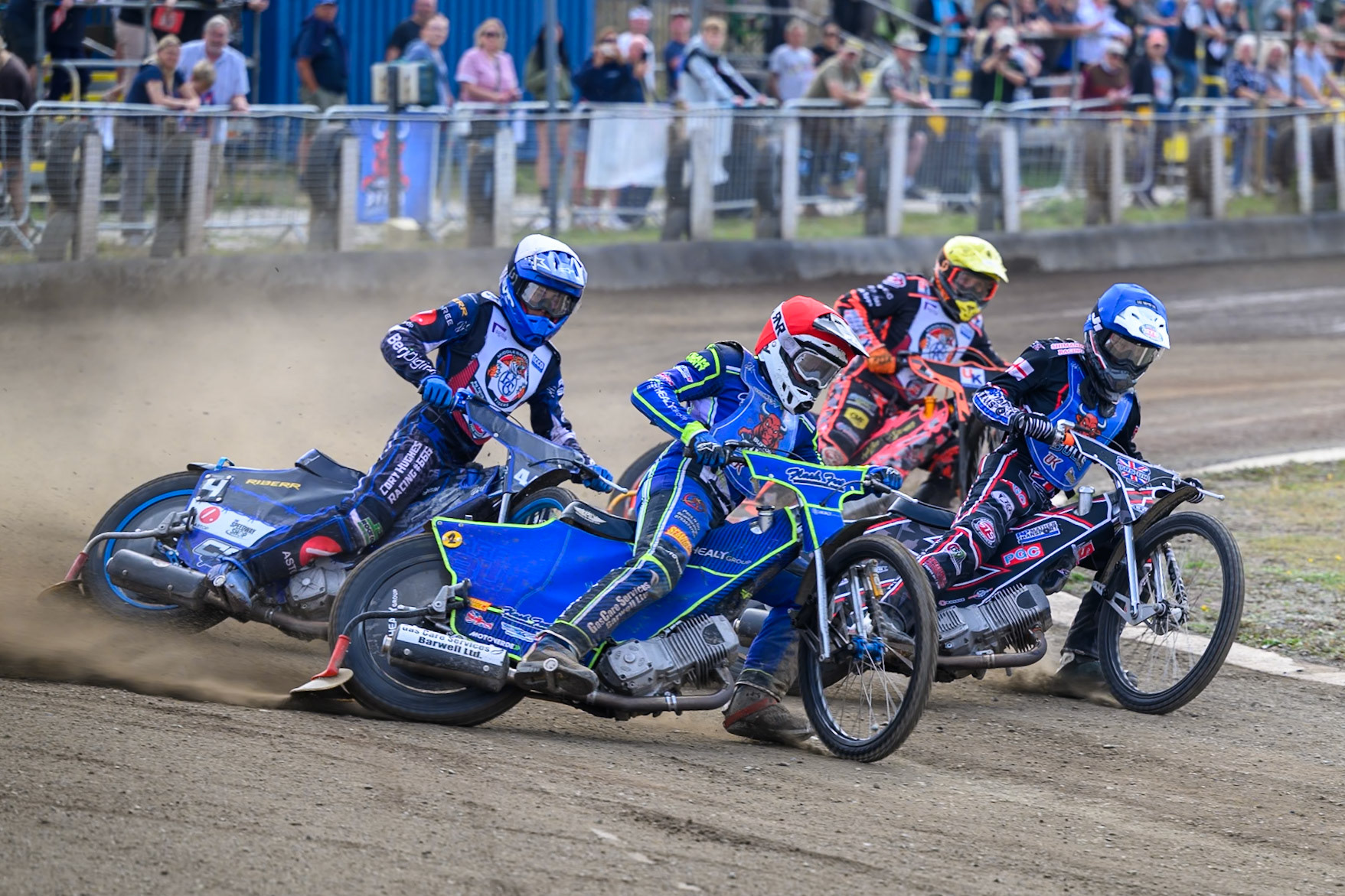 Arran Butcher of Buxton Bulls in Red on the outside of Jack Shimelt of Buxton Bulls in Blue  with Charlie Southwick of Middlesborough Tigers in White  and Alex Spooner of Middlesborough Tigers in Yellow  behind during the WSRA National Development League match  between Buxton Bulls and Middlesborough Tigers at Hi-Edge Speedway, Buxton on Sunday 16th August 2026. (Photo: Ian Charles | MI News)