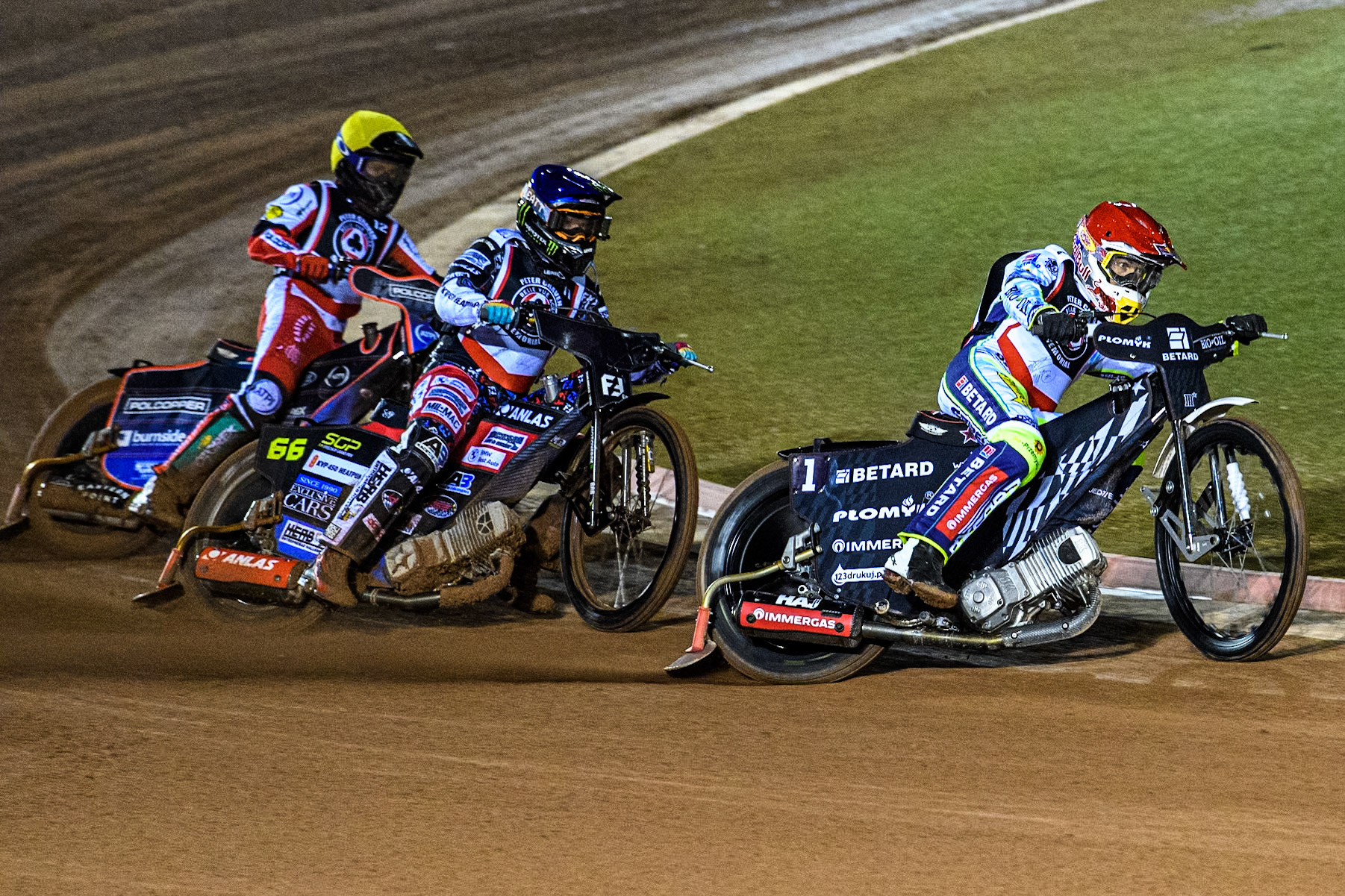 Poland’s Maceij Janowski (Red) leads  Sweden’s Fredrik Lindgren (Blue) and Australia's Brady Kurtz (Yellow) during the Peter Craven Memorial Trophy meeting at the National Speedway Stadium, Manchester on Monday 18th March 2024. (Photo: Ian Charles | MI News)