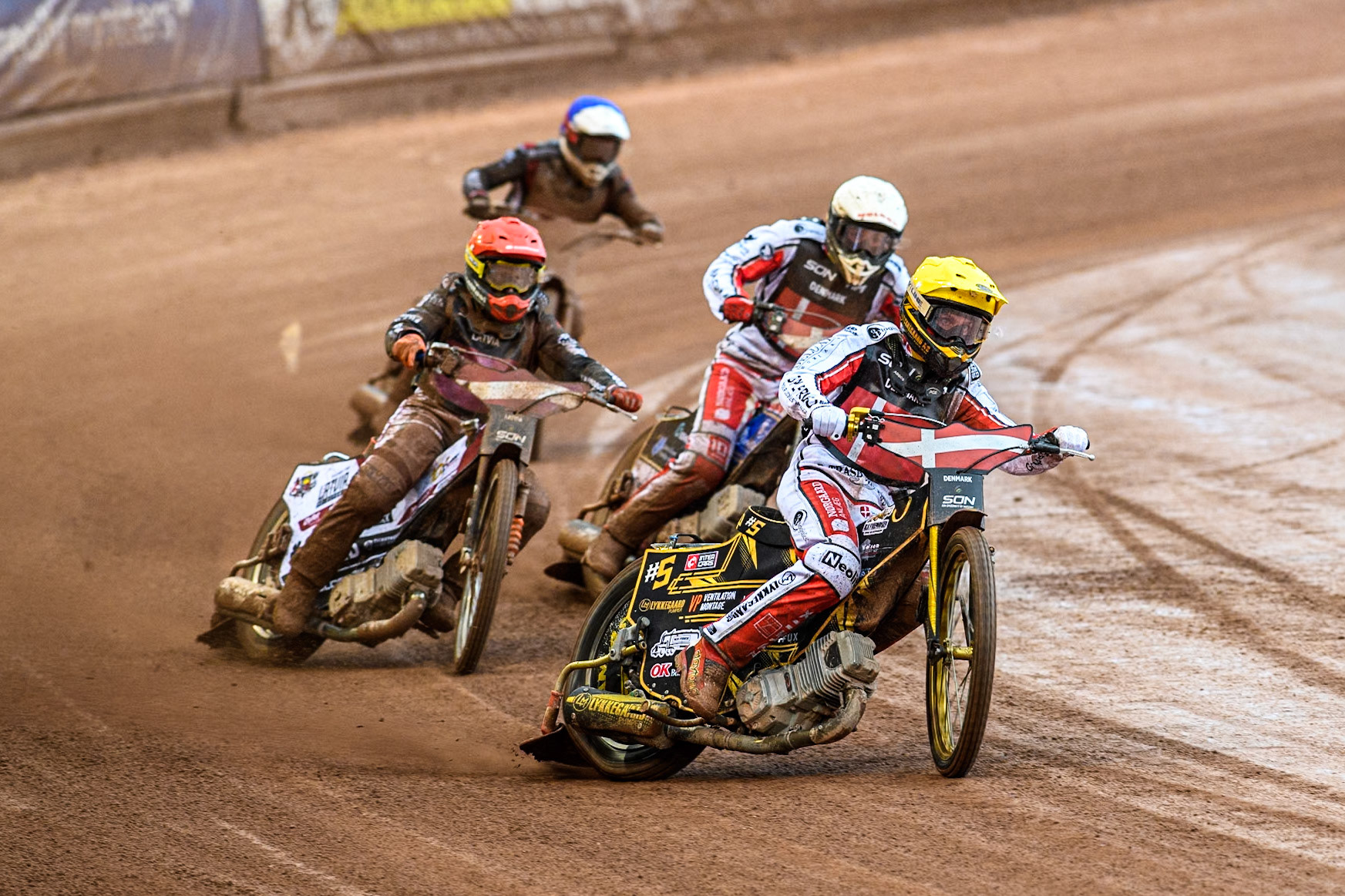 Anders Thomsen of Denmark in Yellow leading Rasmus Jensen of Denmark in White Andzejs Lebedevs of Latvia in Red and Francis Gusts of Latvia in Blue during the Monster Energy FIM Speedway of Nation Semi Final 2 at the National Speedway Stadium, Manchester on Wednesday 10th July 2024. (Photo: Ian Charles | MI News)