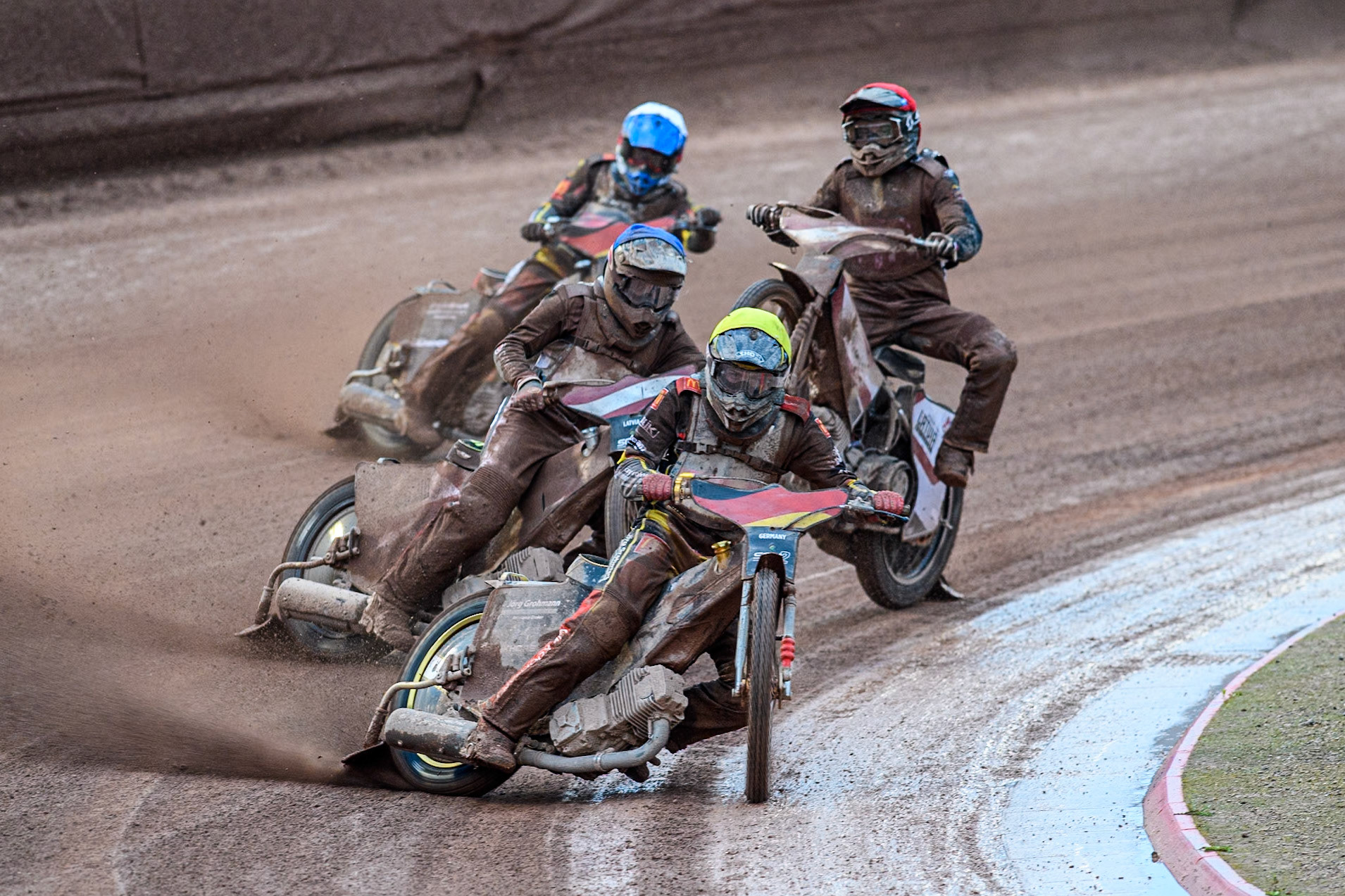 Norick Blödorn of Germany in Yellow leading Nikita Kaulins of Latvia in Blue as Artjoms Juhno of Latvia in Red picks up some drive ahead of Patrick Hyjek of Germany in White during the Monster Energy FIM Speedway of Nations 2 (Under 21) Final at the National Speedway Stadium, Manchester on Friday 12th July 2024. (Photo: Ian Charles | MI News)