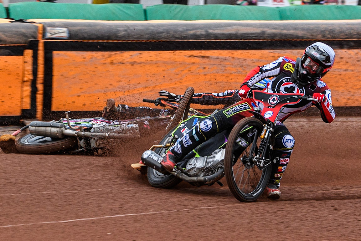 Tom Brennan (White) inside Leon Flint (Blue) as he falls in the first bend during the Sports Insure Premiership match between Wolverhampton Wolves and Belle Vue Aces at Monmore Green Stadium, Wolverhampton on Monday 10th July 2023. (Photo: Ian Charles | MI News)