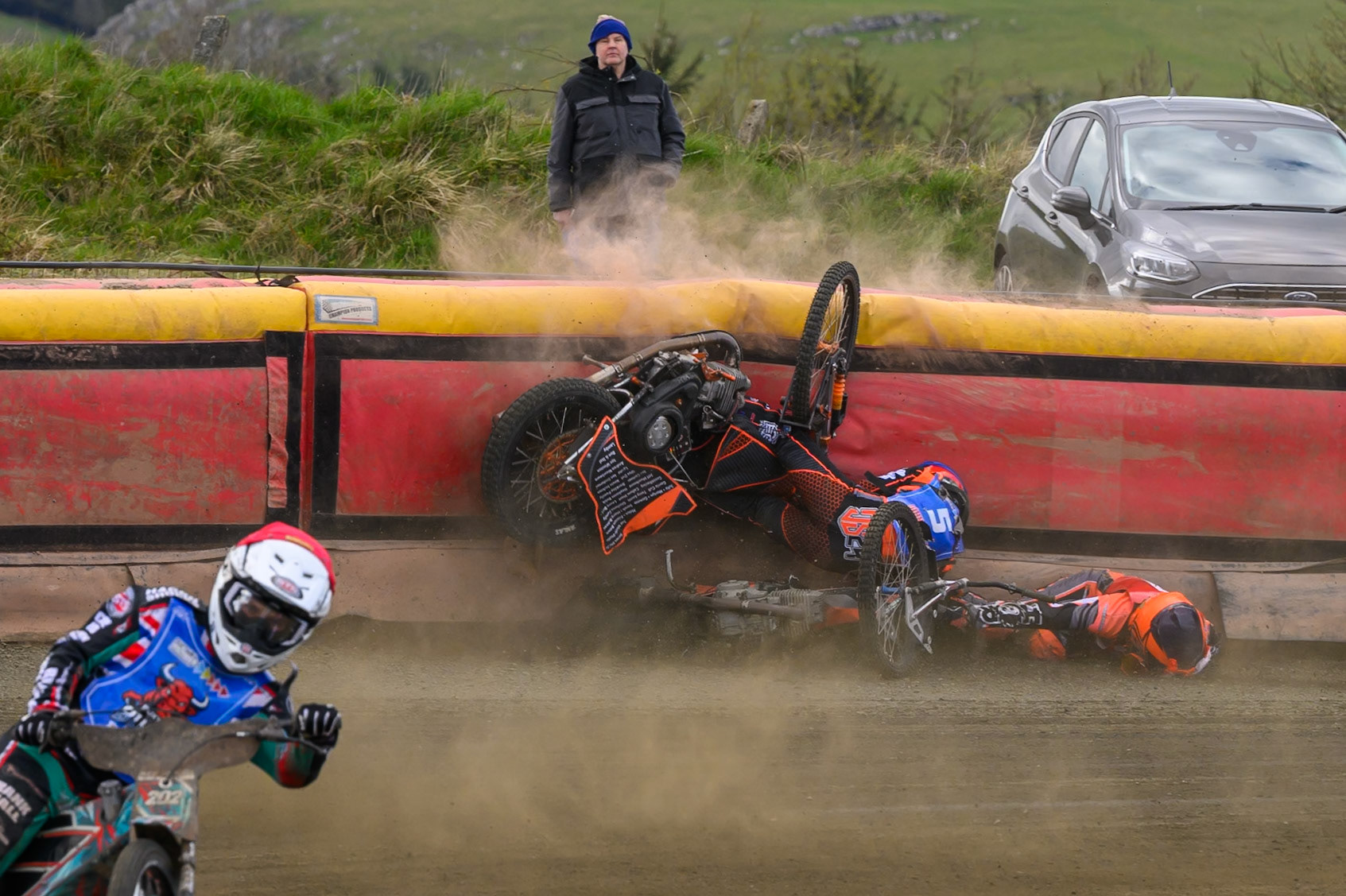 Connor Coles of NDL Nomads   in White fall and Jack Smith of Buxton Bulls   in Blue collides with him during the  Challenge match between Buxton Bulls and NDL Nomads at Hi-Edge Speedway, Buxton on Sunday 19th April 2026. (Photo: Ian Charles | MI News)