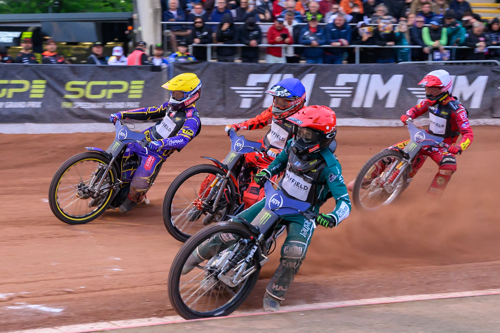 Leon Madsen (30) of Denmark in Red rides inside Jan Kvech (201) of Czech Republic in Blue Kacper Woryna (223) of Poland in Yellow and Max Fricke (46) of Australia in White during the ATPI  FIM Speedway GP of Manchester at the National Speedway Stadium, Manchester on Friday 5th June 2026. (Photo: Ian Charles | MI News)
