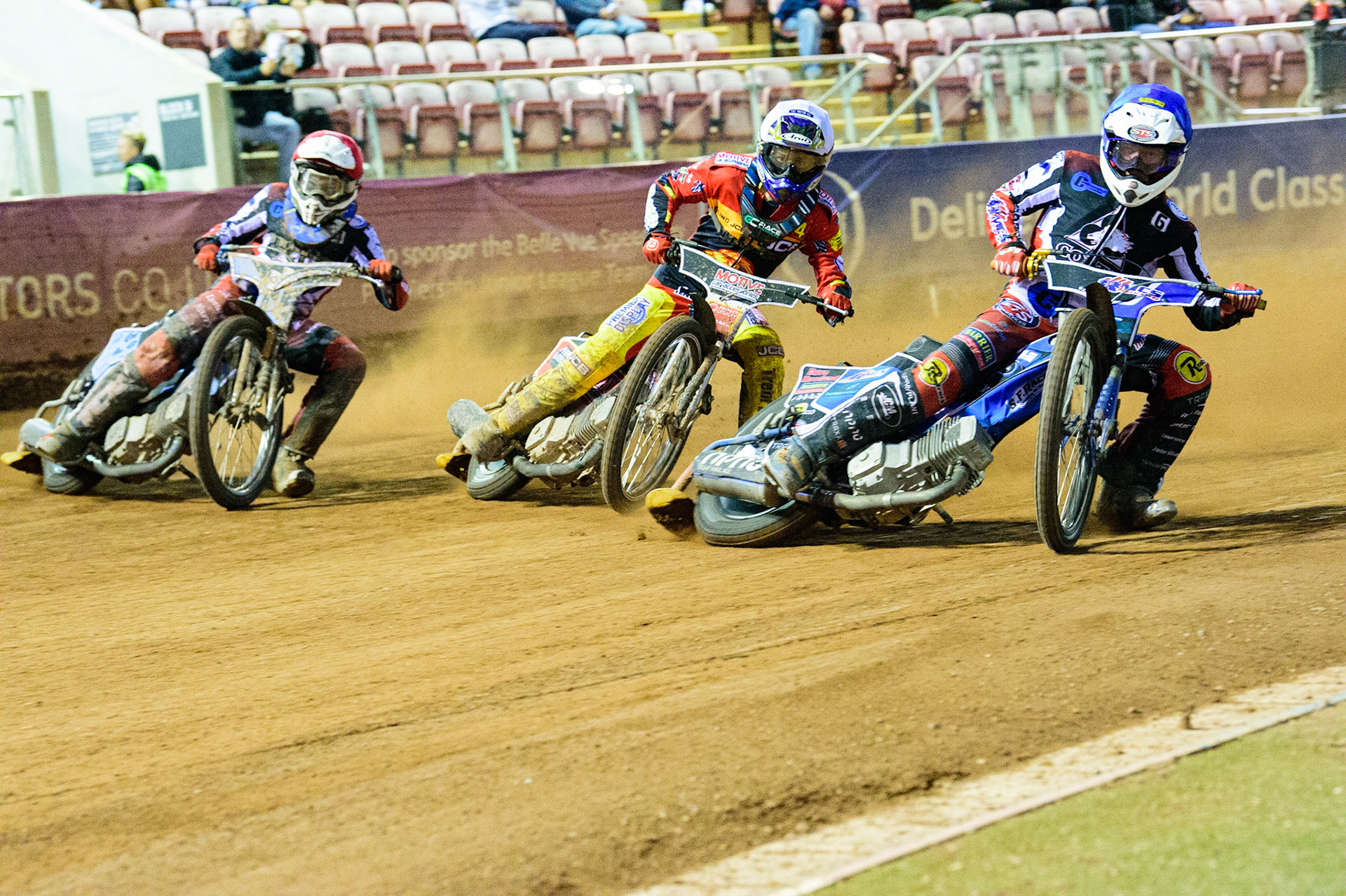 Archie Freeman  (Blue) passes Tom Spencer  (White) and Sam McGurk  (Red) on the inside during the National Development League match between Belle Vue Aces and Leicester Lions at the National Speedway Stadium, Manchester on Friday 19th August 2022. (Credit: Ian Charles | MI News)