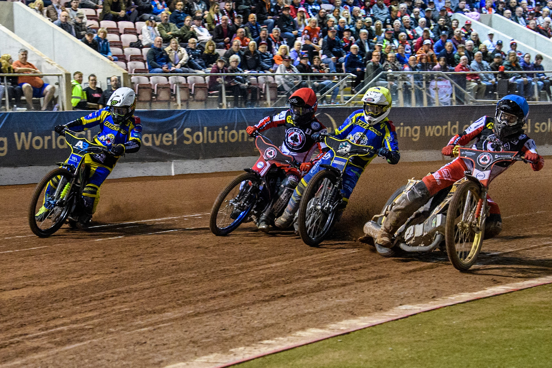 Belle Vue Aces' Norick Blodorn in Blue rides inside Sheffield Tigers' Josh Pickering  in Yellow, Belle Vue Aces' Brady Kurtz  in Red and Sheffield Tigers' Chris Holder  in White during the Rowe Motor Oil Premiership Play Off Semi Final 2, 1st Leg match between Belle Vue Aces and Sheffield Tigers at the National Speedway Stadium, Manchester on Monday 16th September 2024. (Photo: Ian Charles | MI News)