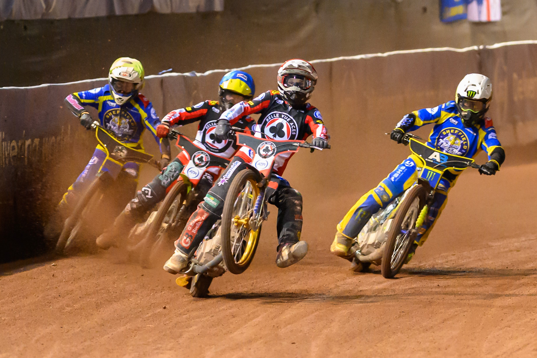 Jason Doyle of Belle Vue Aces in Red picks up some drive ahead of Tate Zischke of Belle Vue Aces in Blue Chris Holder of Sheffield Tigers in White and Leon Flint of Sheffield Tigers in Yellow during the Rowe Motor Oil Premiership match between Belle Vue Aces and Sheffield Tigers at the National Speedway Stadium, Manchester on Monday 14th September 2026. (Photo: Ian Charles | MI News)