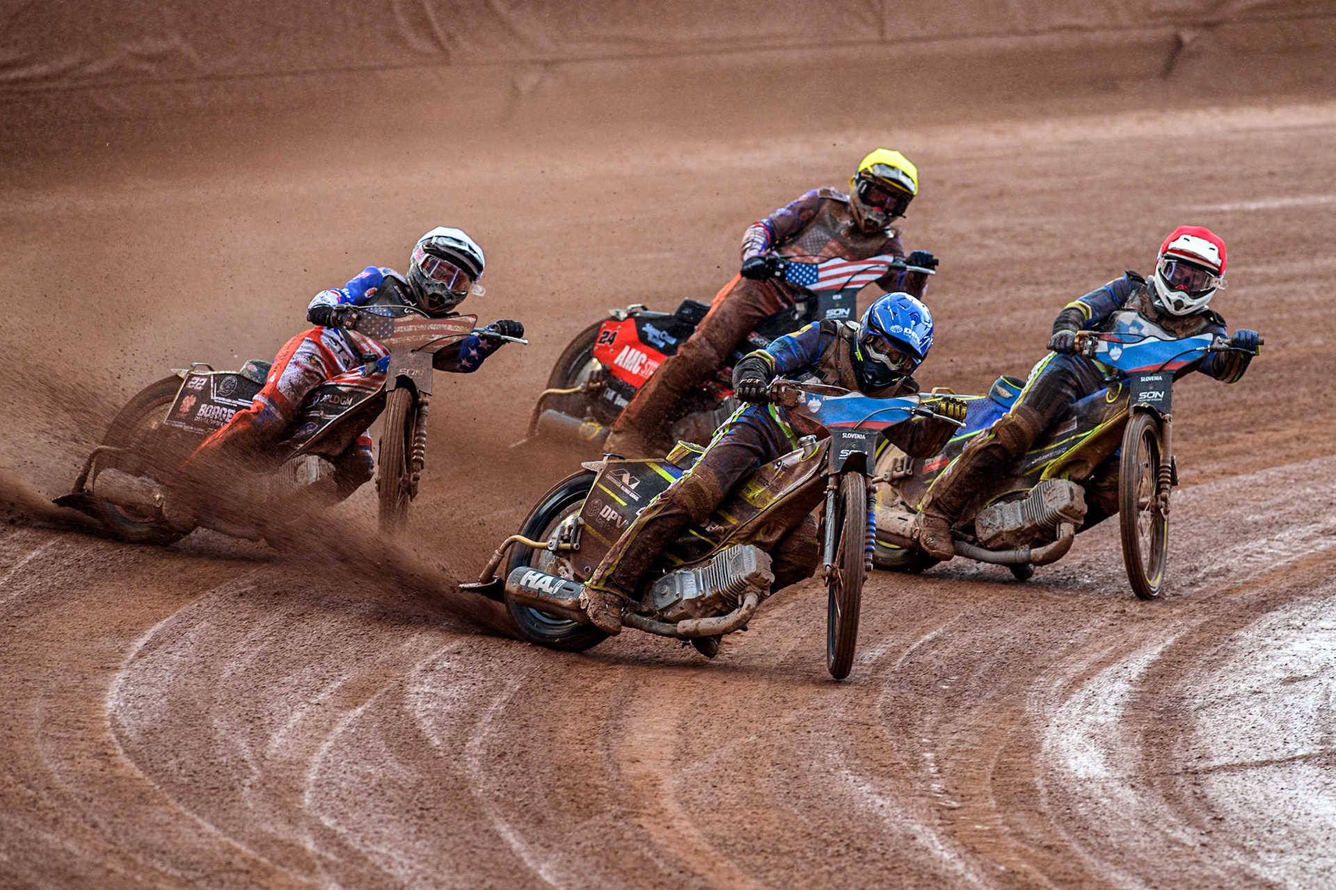 Slovenia v USA: Matic Ivacic of Slovenia in Blue leading Anze Grmek of Slovenia in Red, Luke Becker of the USA in White and Gino Manzares of the USA in Yellow  during the Monster Energy FIM Speedway of Nation Semi Final 2 at the National Speedway Stadium, Manchester on Wednesday 10th July 2024. (Photo: Ian Charles | MI News)