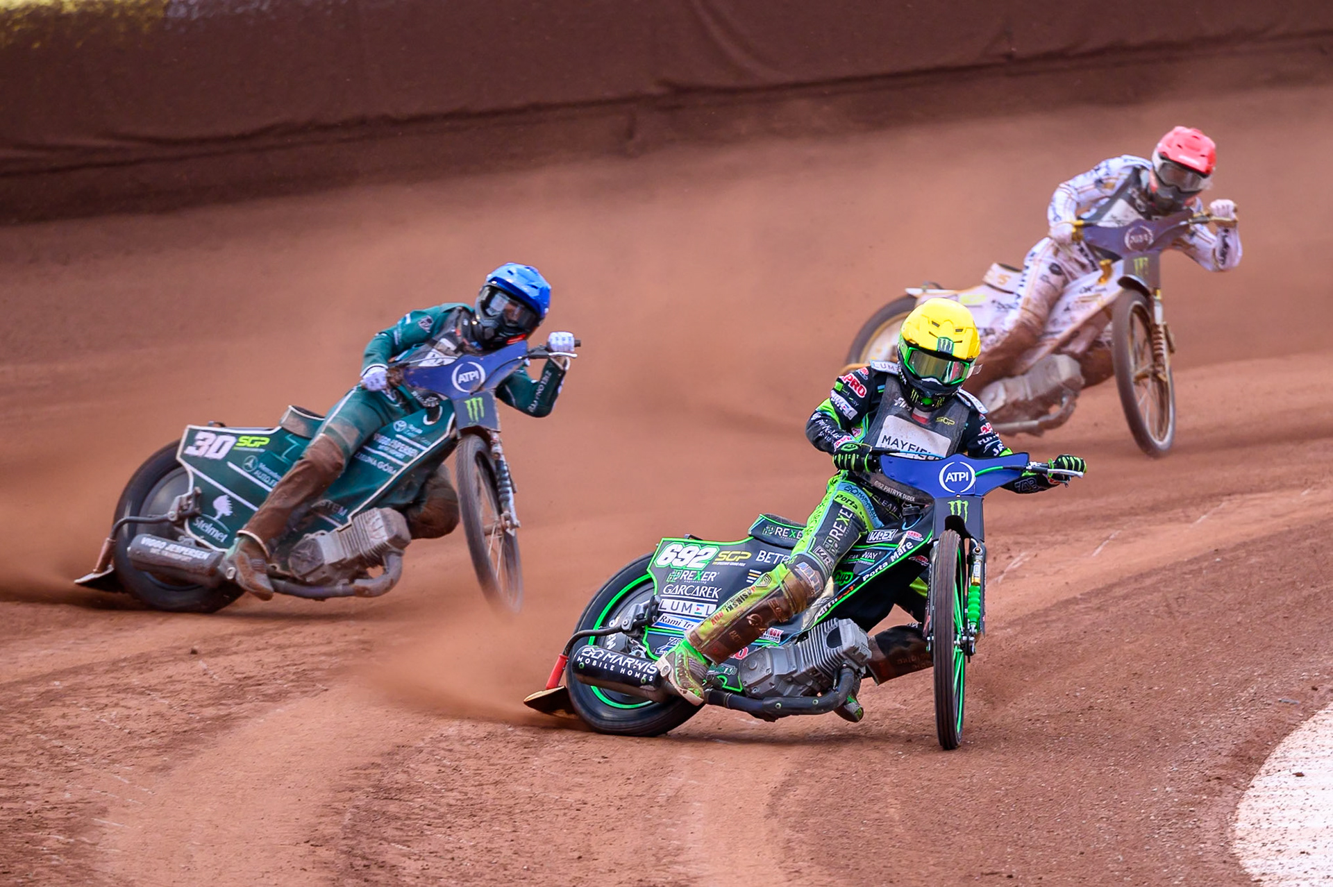Patryk Dudek (692) of Poland in Yellow leading Leon Madsen (30) of Denmark in Blue and Anders Thomsen (105) of Denmark in Red during the ATPI  FIM Speedway GP of Manchester at the National Speedway Stadium, Manchester on Saturday 6th June 2026. (Photo: Ian Charles | MI News)
