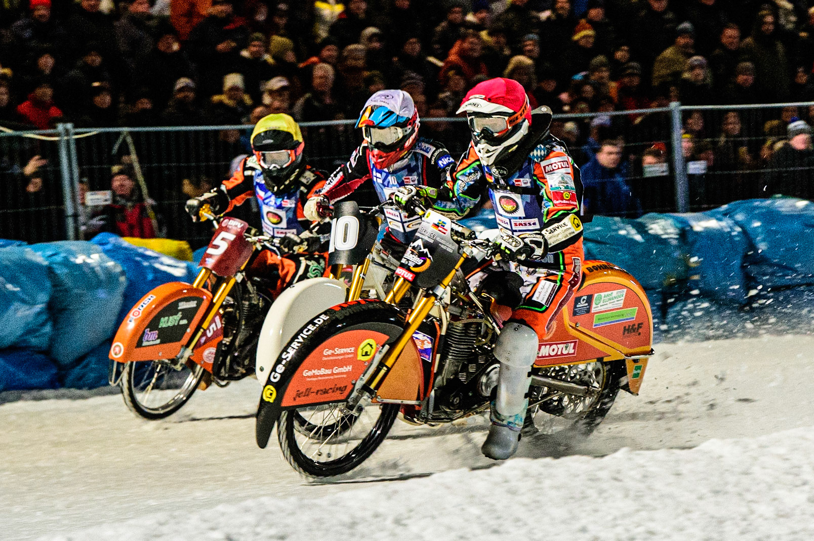 Markus Jell (Red) inside Topi Mustonen (White) and Lukas Hutla in action during the German Individual Ice Speedway Championship at Horst-Dohm-Eisstadion, Berlin on Friday 3rd March 2023. (Photo: Ian Charles | MI News)