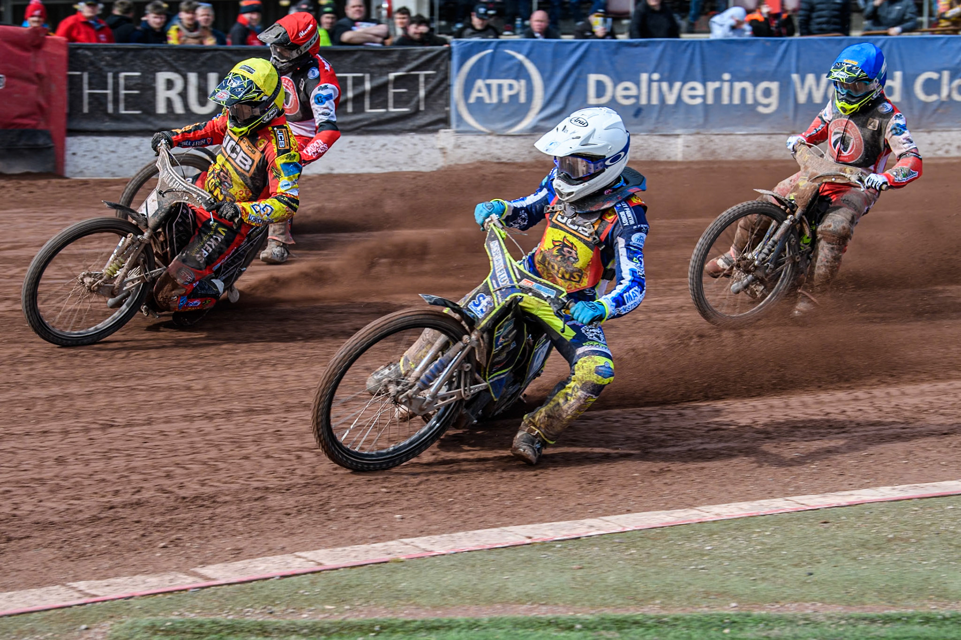 Leicester Lion Cubs' Jody Scott (White) inside Leicester Lion Cubs' Luke Crang (Yellow) and Belle Vue Colts' Matt Marson (Red) with Belle Vue Colts' Luke Muff behind during the WSRA National Development League match between Belle Vue Colts and Leicester Lion Cubs at the National Speedway Stadium, Manchester on Friday 29th March 2024. (Photo: Ian Charles | MI News)