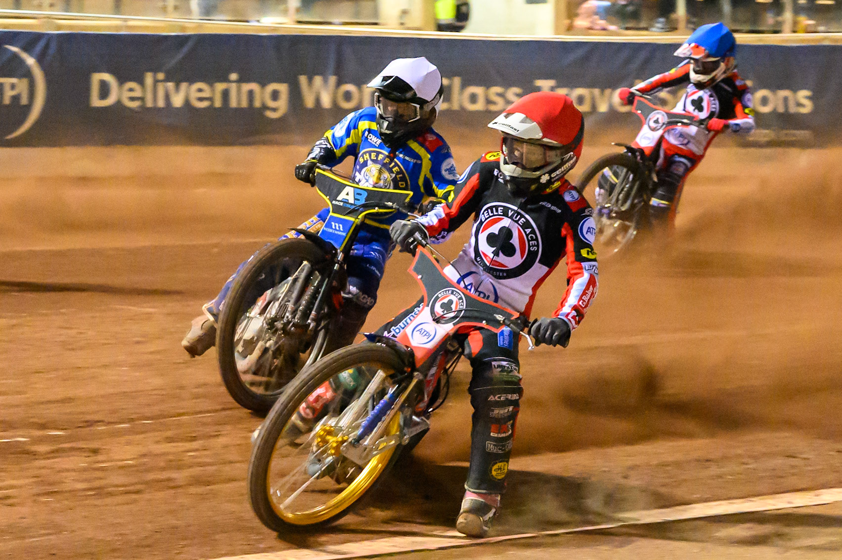 Jason Doyle of Belle Vue Aces in Red on the inside of Ben Cook, Guest Rider for Sheffield Tigers in White  with Zach Cook of Belle Vue Aces in Blue  behind during the Rowe Motor Oil Premiership match between Belle Vue Aces and Sheffield Tigers at the National Speedway Stadium, Manchester on Monday 14th September 2026. (Photo: Ian Charles | MI News)