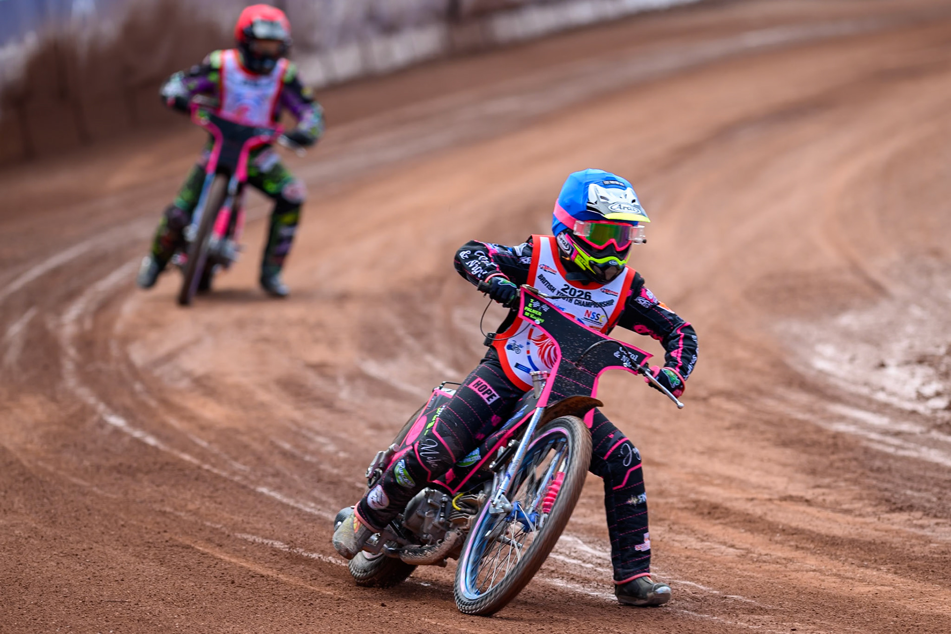125cc SUPPORT CLASS Jessica Cox (61) in Blue leading John Cox (13) in Red during the British Youth Championship (125cc) at the National Speedway Stadium, Manchester on Sunday 19th July 2026. (Photo: Ian Charles | MI News)