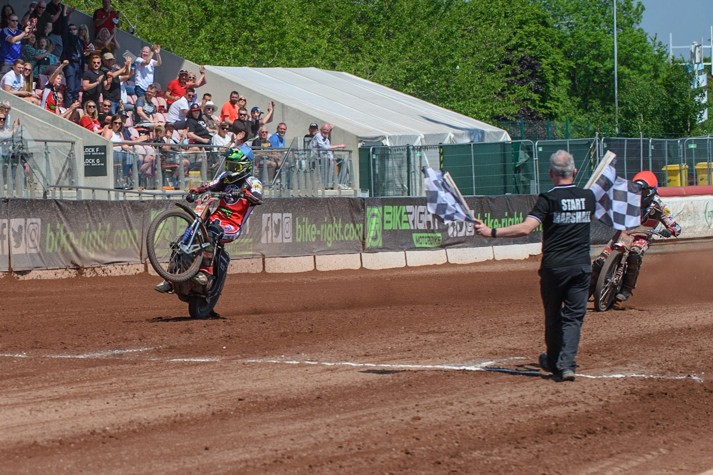 MANCHESTER, UK. MAY 31ST  Dan Bewley  (White) wheelies over the finish line to win Heat 15 during the SGB Premiership match between Belle Vue Aces and Peterborough at the National Speedway Stadium, Manchester on Monday 31st May 2021. (Credit: Ian Charles | MI News)