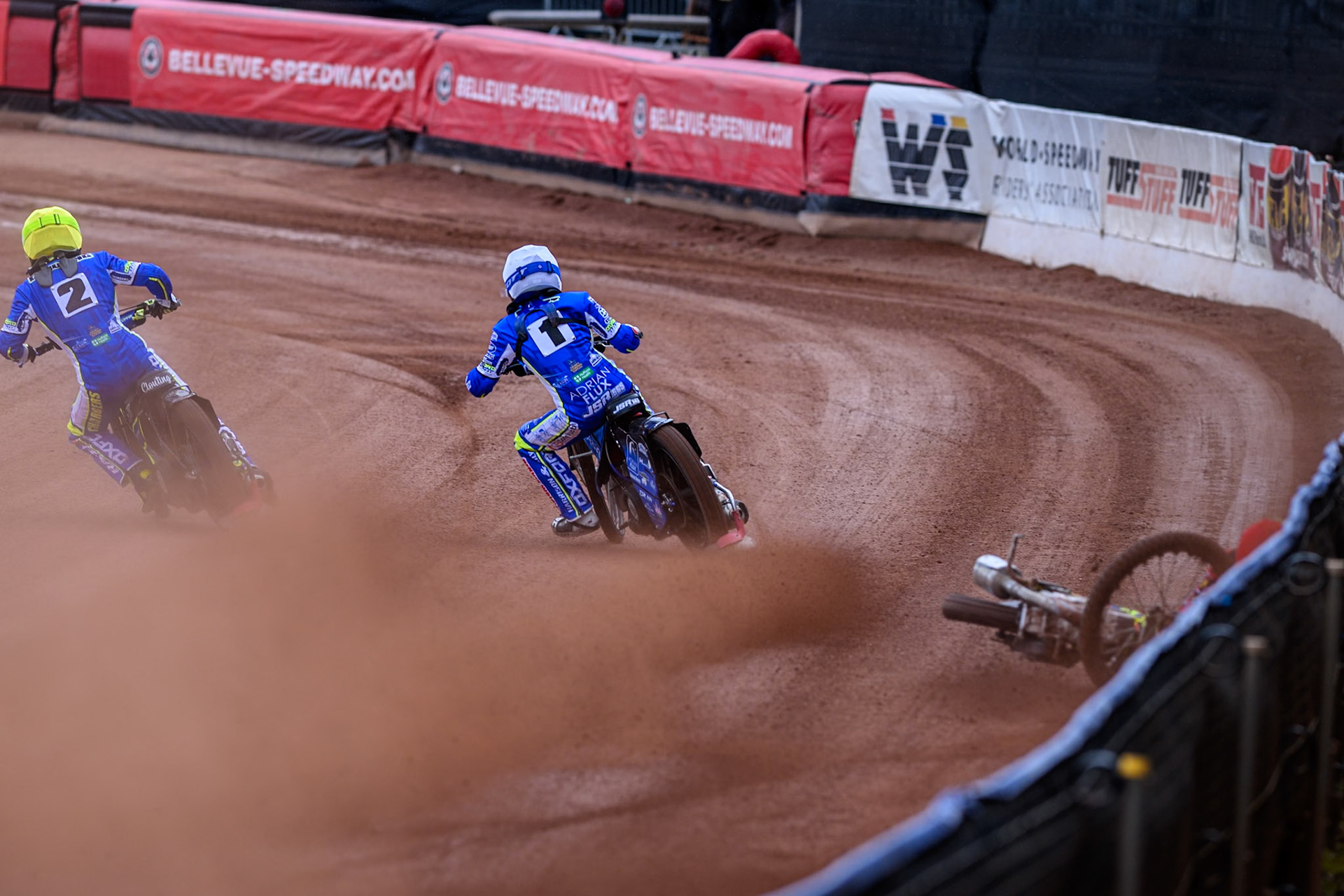 Belle Vue Colts' William Cairns falls whilst trying to pass Oxford Chargers' Jody Scott  in White and Oxford Chargers' Jacob Clouting  in Yellow during the WSRA National Development League match between Belle Vue Colts and Oxford Chargers at the National Speedway Stadium, Manchester on Sunday 1st June 2025. (Photo: Ian Charles | MI News)