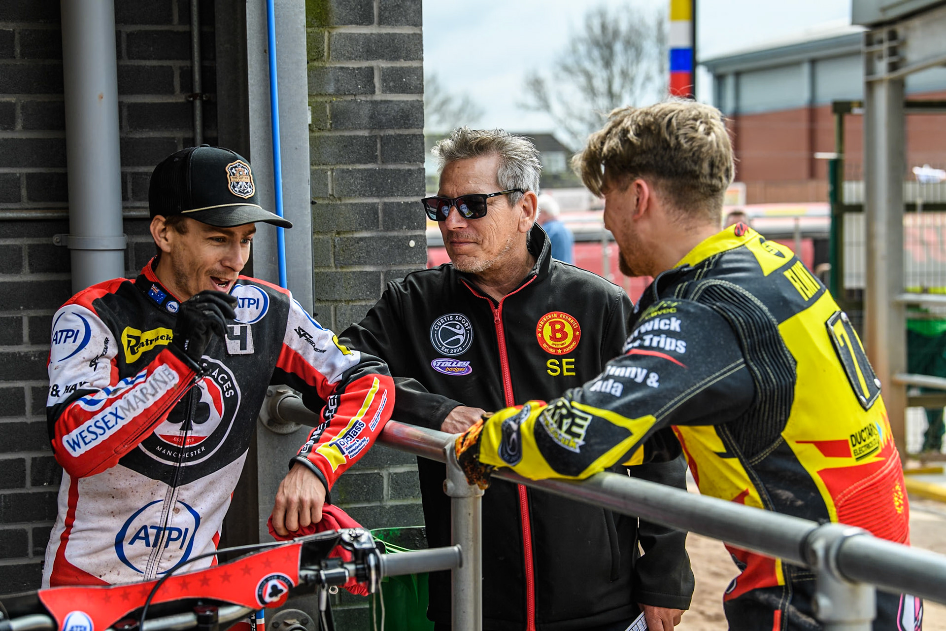 (L to R) Belle Vue Aces' Ben Cook  Birmingham Brummies' Team Manager Sam Ermolenko  and Birmingham Brummies' Leon Flint  as they discuss the last heat where Cook just beat Flint on the finish line during the Rowe Motor Oil Premiership match between Belle Vue Aces and Birmingham Brummies at the National Speedway Stadium, Manchester on Monday 6th May 2024. (Photo: Ian Charles | MI News)