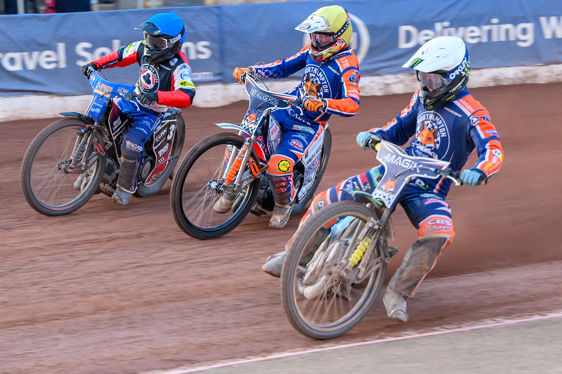 Jaimon Lidsey of Northampton Foxes  in White rides inside Nicolai Klindt of Northampton Foxes in Yellow and Ben Cook, Guest Rider for Belle Vue Aces in Blue during the Rowe Motor Oil Premiership match between Belle Vue Aces and Northampton Foxes at the National Speedway Stadium, Manchester on Monday 13th July 2026. (Photo: Ian Charles | MI News)
