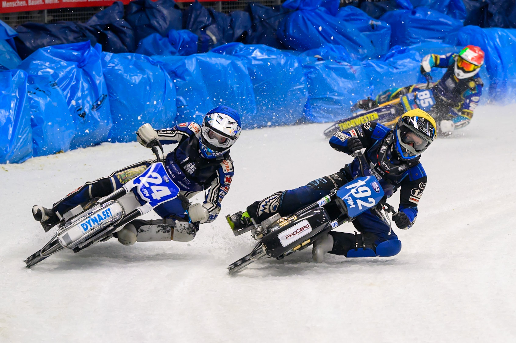 Niclas Svensson (192) of Sweden in Yellow rides inside Max Koivula (24) of Finland with Luca Bauer (85) of Italy/Germany in Red behind during the Ice Speedway Gladiators World Championship Final 2 at Max-Aicher-Arena, Inzell on Sunday 15th March 2026. (Photo: Ian Charles | MI News)