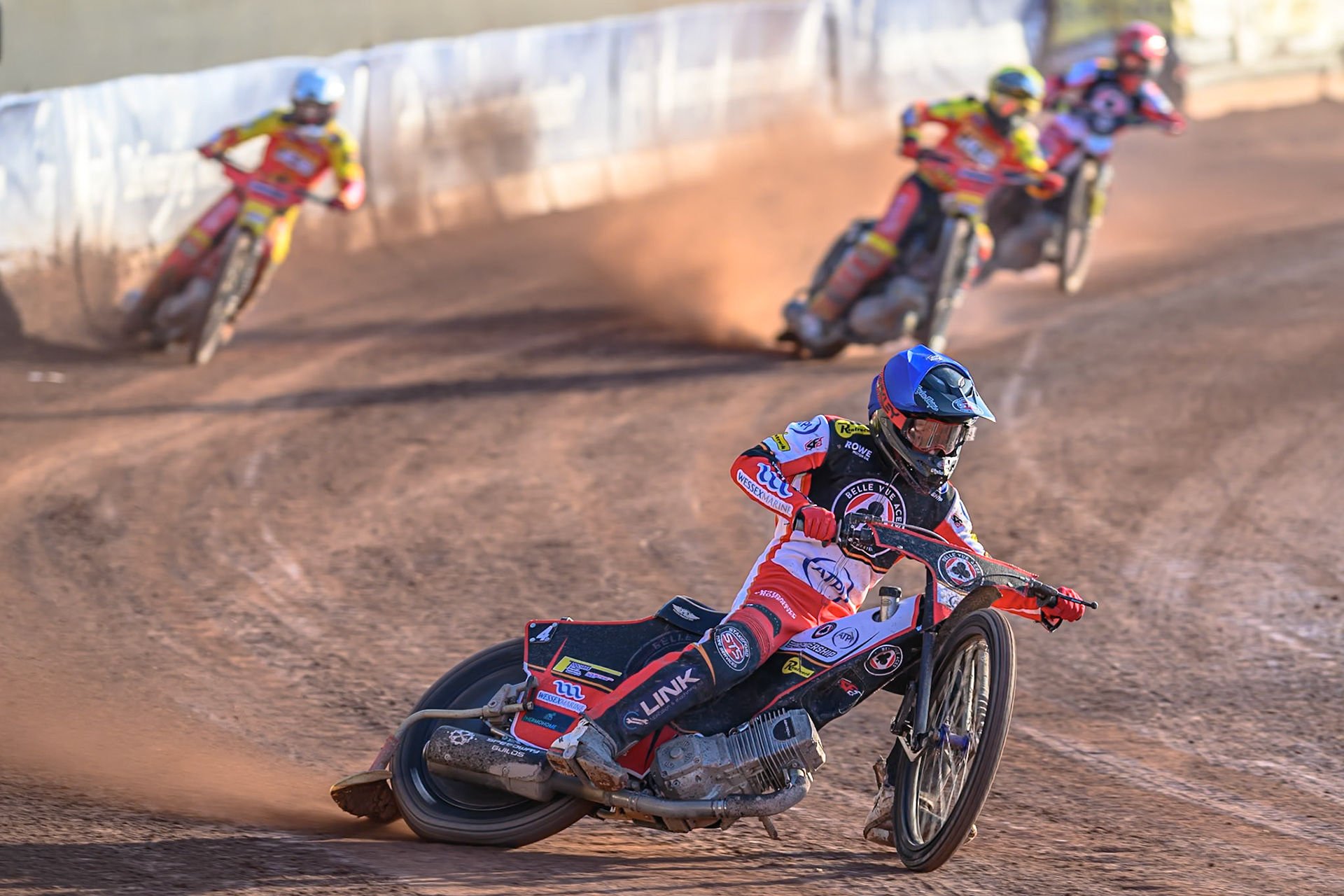 Belle Vue Aces' Zach Cook in Blue leading Leicester Lions' Ryan Douglas in Yellow, Leicester Lions' Max Fricke  in White and Belle Vue Aces' Jaimon Lidsey in Red  during the Rowe Motor Oil Premiership match between Belle Vue Aces and Leicester Lions at the National Speedway Stadium, Manchester on Monday 14th July 2025. (Photo: Ian Charles | MI News)