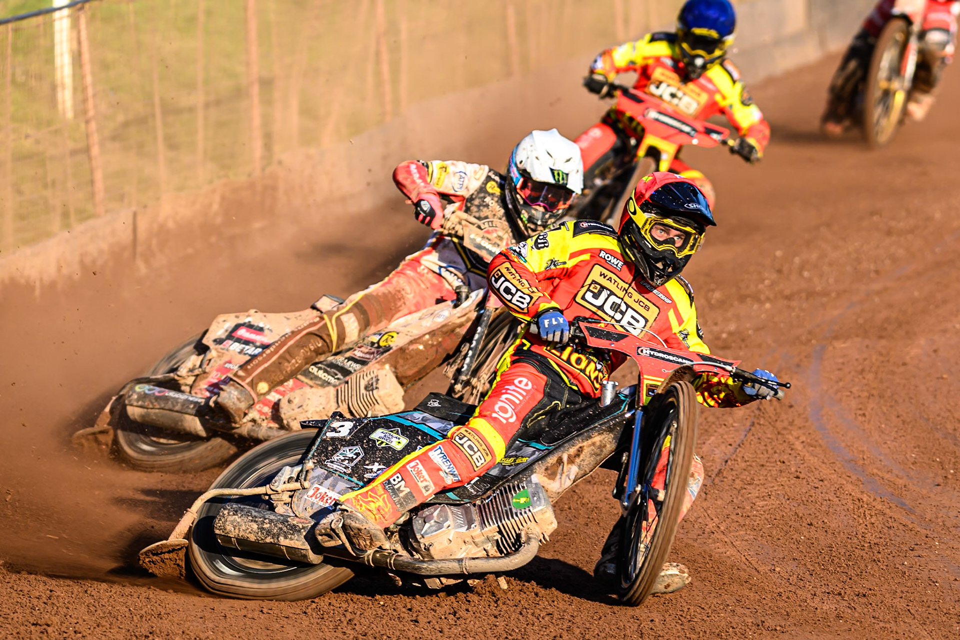 Leicester Lions' Ryan Douglas in Red leading Belle Vue Aces' Dan Bewley in White and Leicester Lions' Kyle Howarth in Blue during the Rowe Motor Oil Premiership match between Leicester Lions and Belle Vue Aces at the Hydroscand Arena, Leicester on Thursday 19th June 2025. (Photo: Ian Charles | MI News)