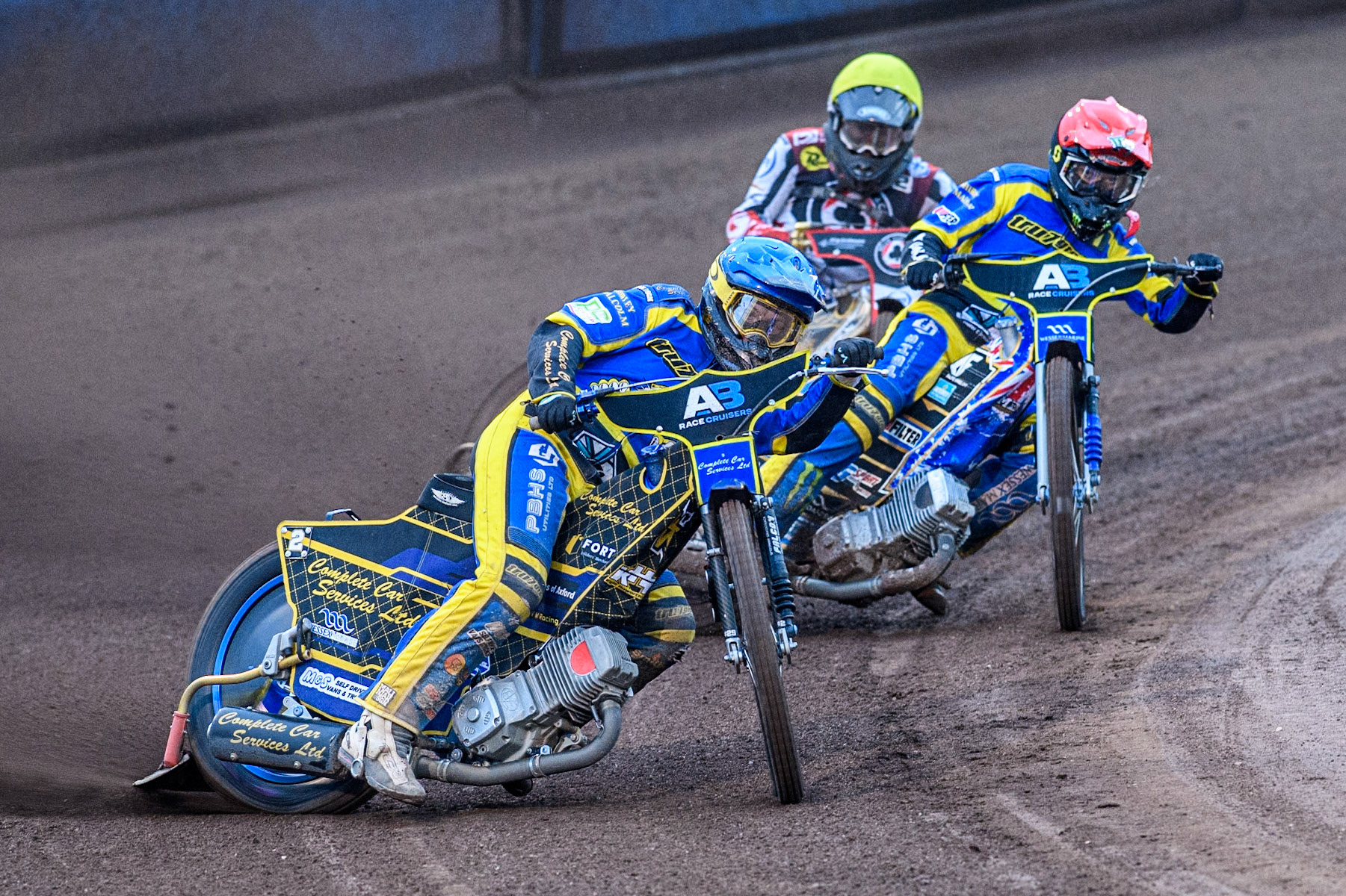 Sheffield Tigers' Kyle Howarth  in Blue leading Sheffield Tigers' Jack Holder  in Red and Belle Vue Aces' Norick Blödorn  in Yellow during the Rowe Motor Oil Premiership match between Sheffield Tigers and Belle Vue Aces at Owlerton Stadium, Sheffield on Monday 26th August 2024. (Photo: Ian Charles | MI News)