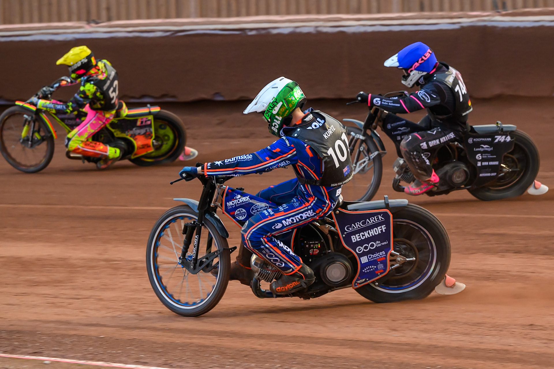 Brady Kurtz (101) of Australia in White rides inside Kai Huckenbeck (744) of Germany in Blue with Michael Jepsen Jensen (52) of Denmark in Yellow ahead during the ATPI  FIM Speedway GP of Manchester at the National Speedway Stadium, Manchester on Saturday 6th June 2026. (Photo: Ian Charles | MI News)