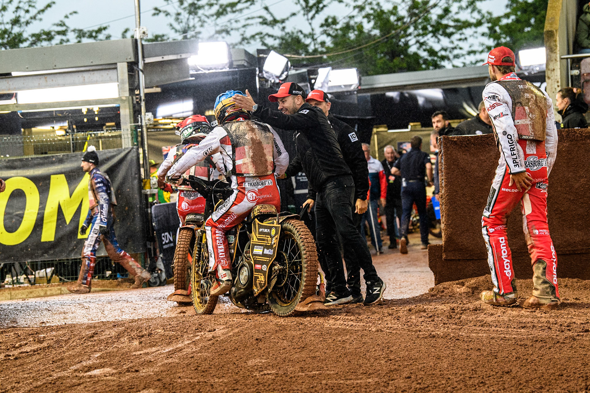 The Danes are congratulated by their team mate and manager after their meeting winning heat during the Monster Energy FIM Speedway of Nation Semi Final 2 at the National Speedway Stadium, Manchester on Wednesday 10th July 2024. (Photo: Ian Charles | MI News)