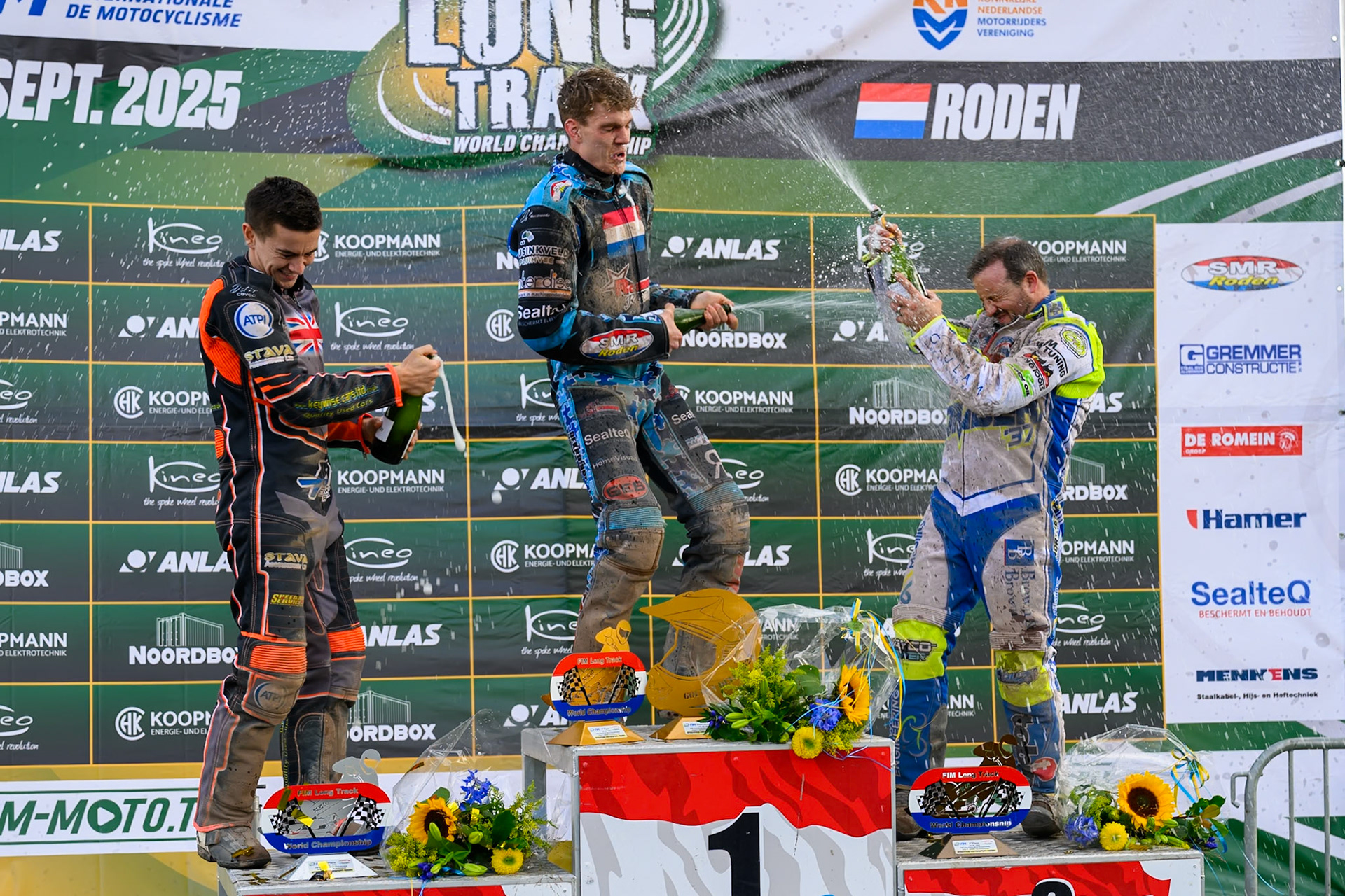 Champagne capers after the Meeting final (L to R) Zach Wajtknecht (109) of Great Britain (2nd), Dave Meijerink (63) of The Netherlands (winner) and Chris Harris (37) of Great Britain (3rd) during the FIM Long Track World Championship Final 4, at the Speed Centre Roden, Netherlands on Sunday 21st September 2025. (Photo: Ian Charles | MI News)during the FIM Long Track World Championship Final 4, at the Speed Centre, Roden on Sunday 21st September 2025. (Photo: Ian Charles | MI News)