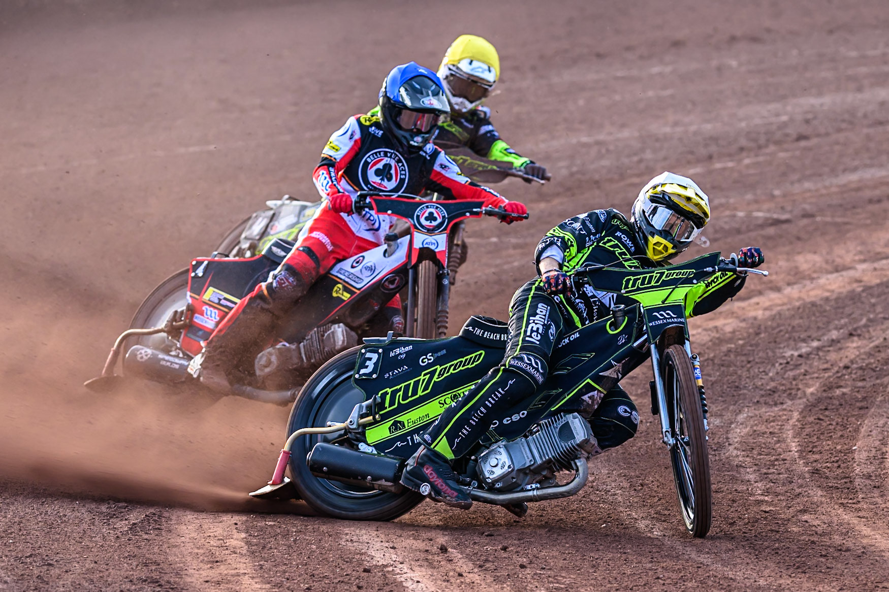 Ipswich Witches' Adam Ellis  in White leading Belle Vue Aces' Zach Cook  in Blue and Ipswich Witches' Tom Brennan  in Yellow during the Rowe Motor Oil Premiership match between Belle Vue Aces and Ipswich Witches at the National Speedway Stadium, Manchester on Monday 30th June 2025. (Photo: Ian Charles | MI News)