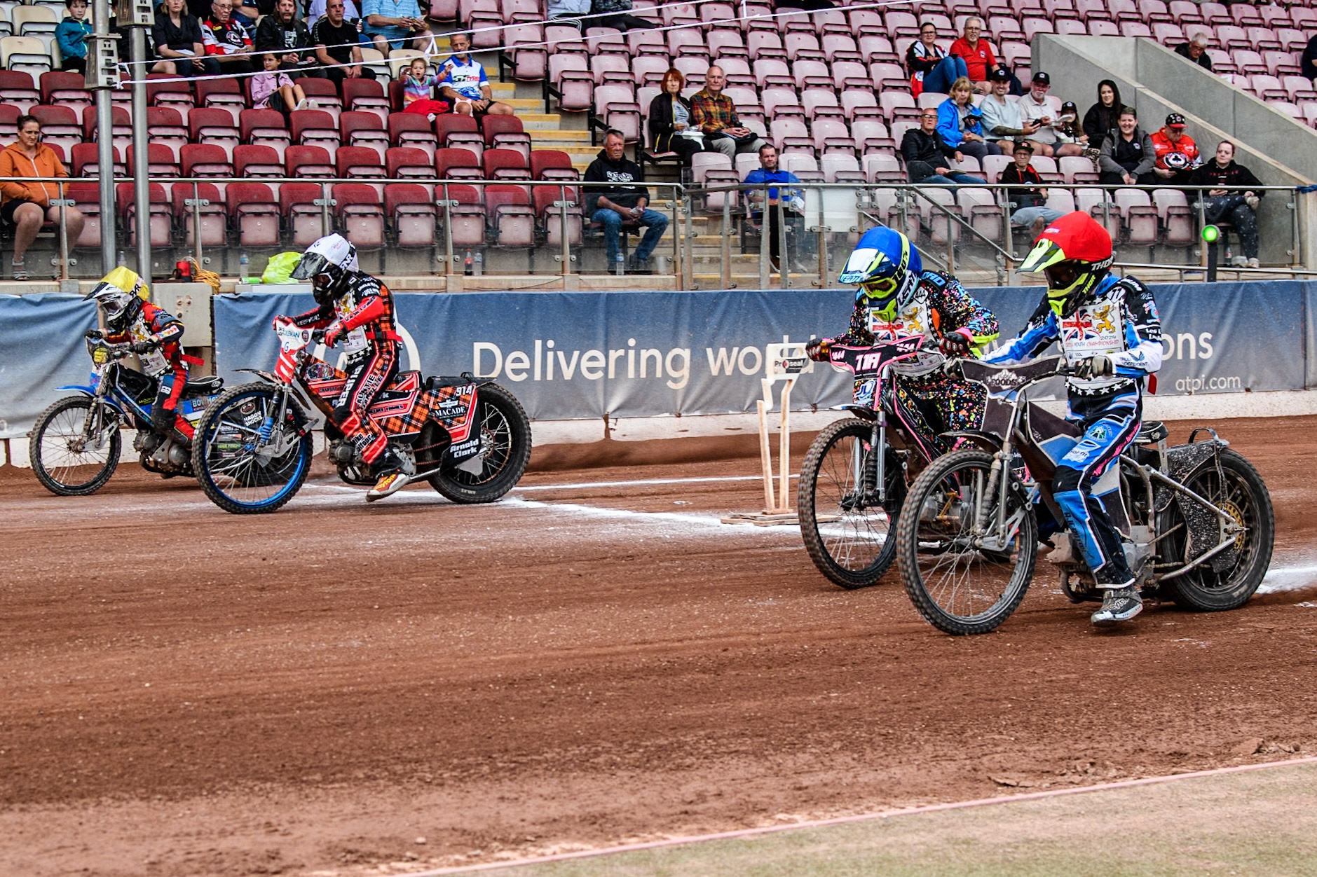 The 125cc Final start: (L to R) Charlie Fletcher (125cc)  in Yellow, Rhys Harrow (125cc)  in White, Tia May Brant (125cc) in Blue and Jack Scully-Syer (125cc)  in Red during the British Youth 500cc Championships at the National Speedway Stadium, Manchester on Friday 2nd August 2024. (Photo: Ian Charles | MI News)