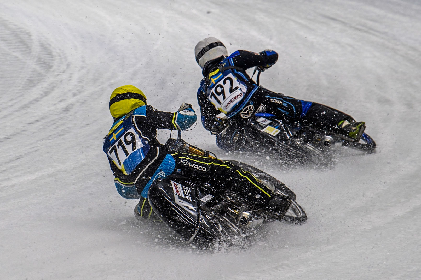 Filip Jäger (719) of Sweden in Yellow chases Niclas Svensson (192) of Sweden in White during the Ice Speedway Gladiators World Championship Final 1 at Max-Aicher-Arena, Inzell on Saturday 15th March 2025. (Photo: Ian Charles | MI News)