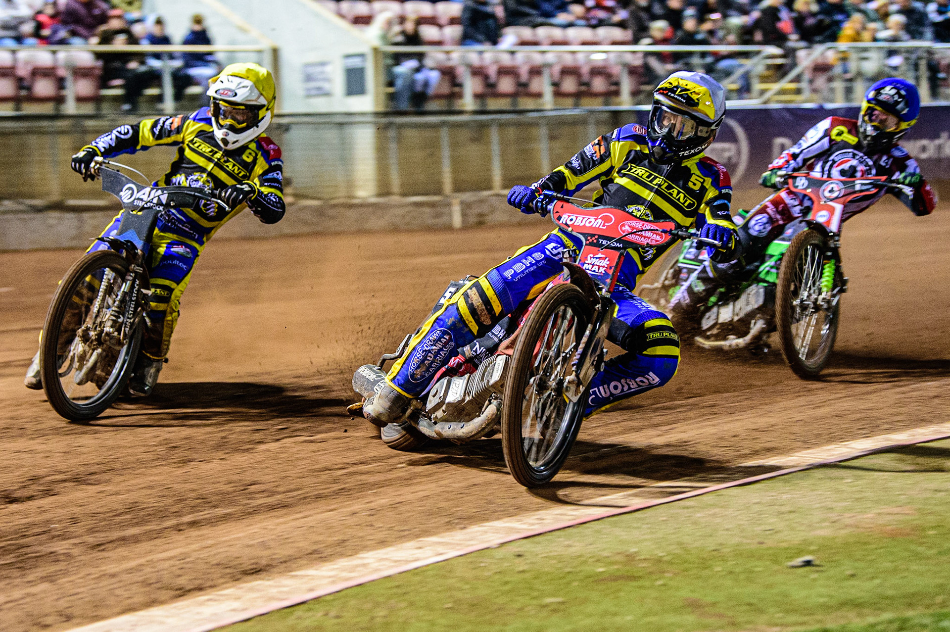 Tobiasz Musielak  (White) and Lewis Kerr  (Yellow) lead Charles Wright  (Blue) during the SGB Premiership match between Belle Vue Aces and Sheffield Tigers at the National Speedway Stadium, Manchester on Monday 27th March 2023. (Photo: Ian Charles | MI News)