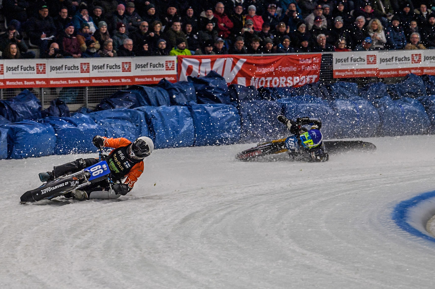 Finland's Aki Ala-Riihimäki (66) (White) leads  as Sweden's Martin Haarahiltunen (199)  (Blue) crashes out during the FIM Ice Speedway Gladiators World Championship Final 2 at the Max-Aicher-Arena, Inzell on Sunday 24 March 2024. (Photo: Ian Charles | MI News)